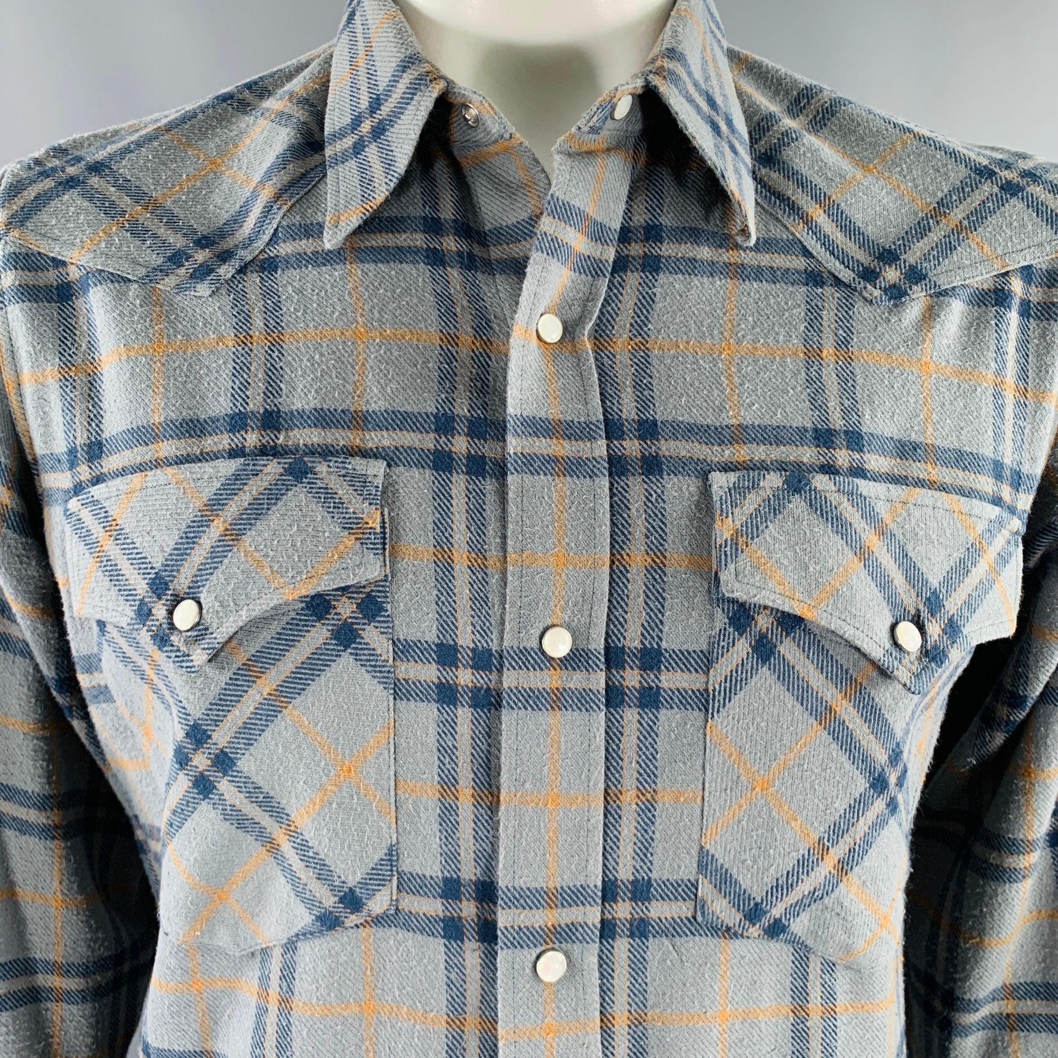 DRIES VAN NOTEN long sleeve shirt
in a blue and yellow cotton woven fabric featuring a Western style, two patch pockets, and mother-of-pearl snap closure. Made in Hungary.Good Pre-Owned Condition. All over pilling, as is. 

Marked:   IT 52