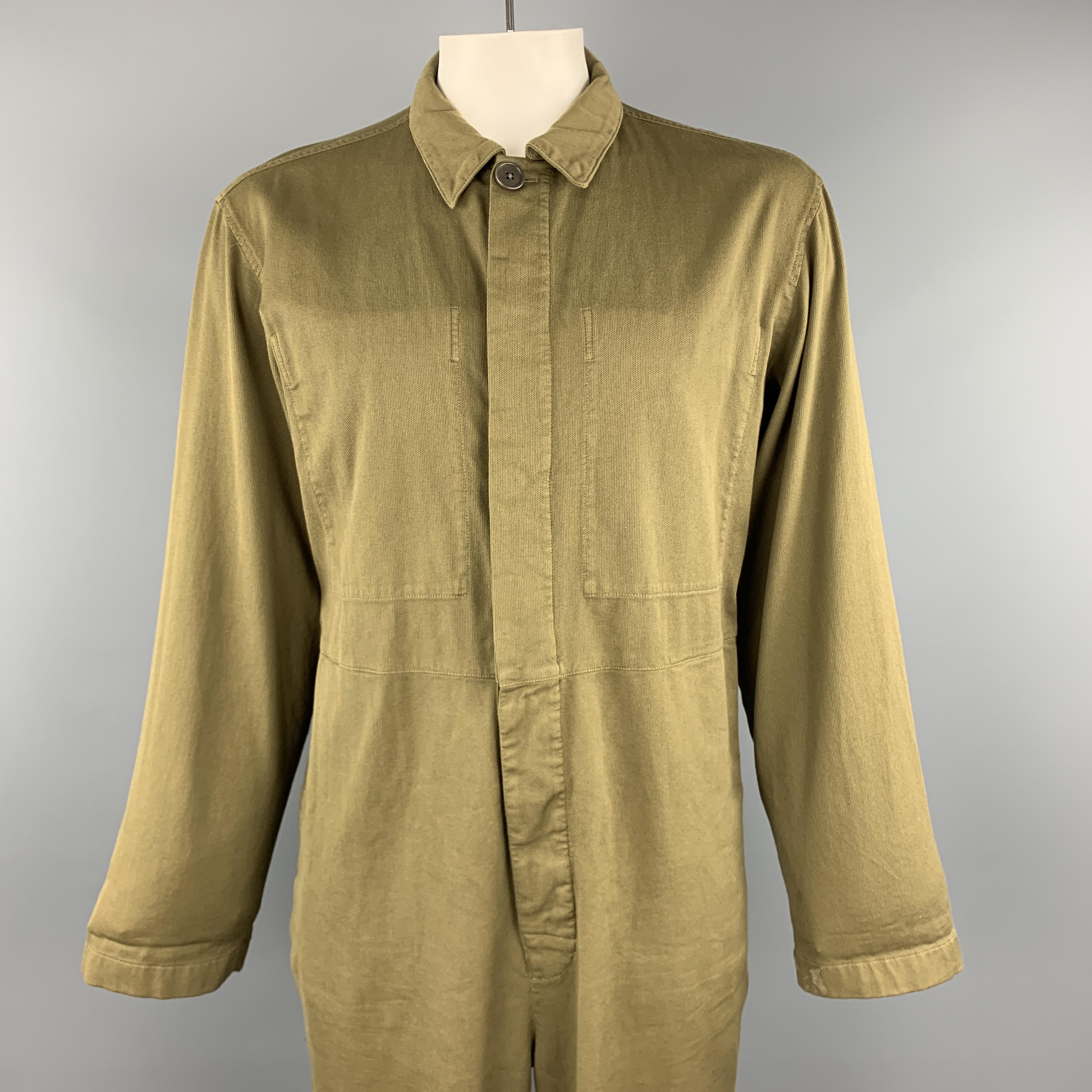 DRIES VAN NOTEN jumpsuit comes in olive cotton canvas with a pointed collar, inner breast pockets, and hidden placket button front. Made in Bulgaria.

Excellent Pre-Owned Condition.
Marked: Large

Measurements:

Shoulder: 20 in.
Chest: 48 in.
Waist: