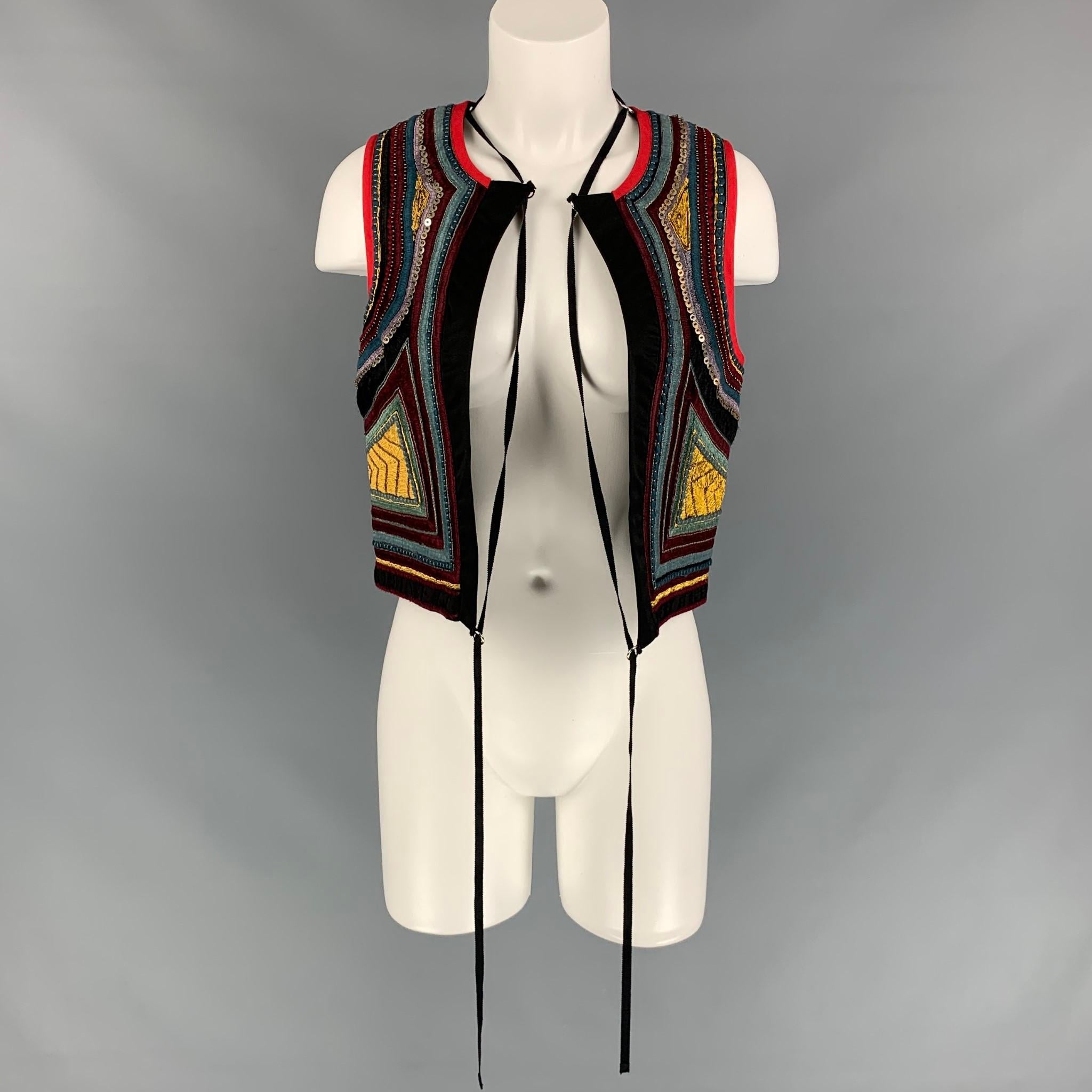 DRIES VAN NOTEN vest comes in a multi-color cotton with embroidered details throughout featuring a cropped style, loop details, beaded, and a open front. Handmade

New With Tags.
Marked: M
Original Retail Price: $1,740.00

Measurements:

Shoulder: