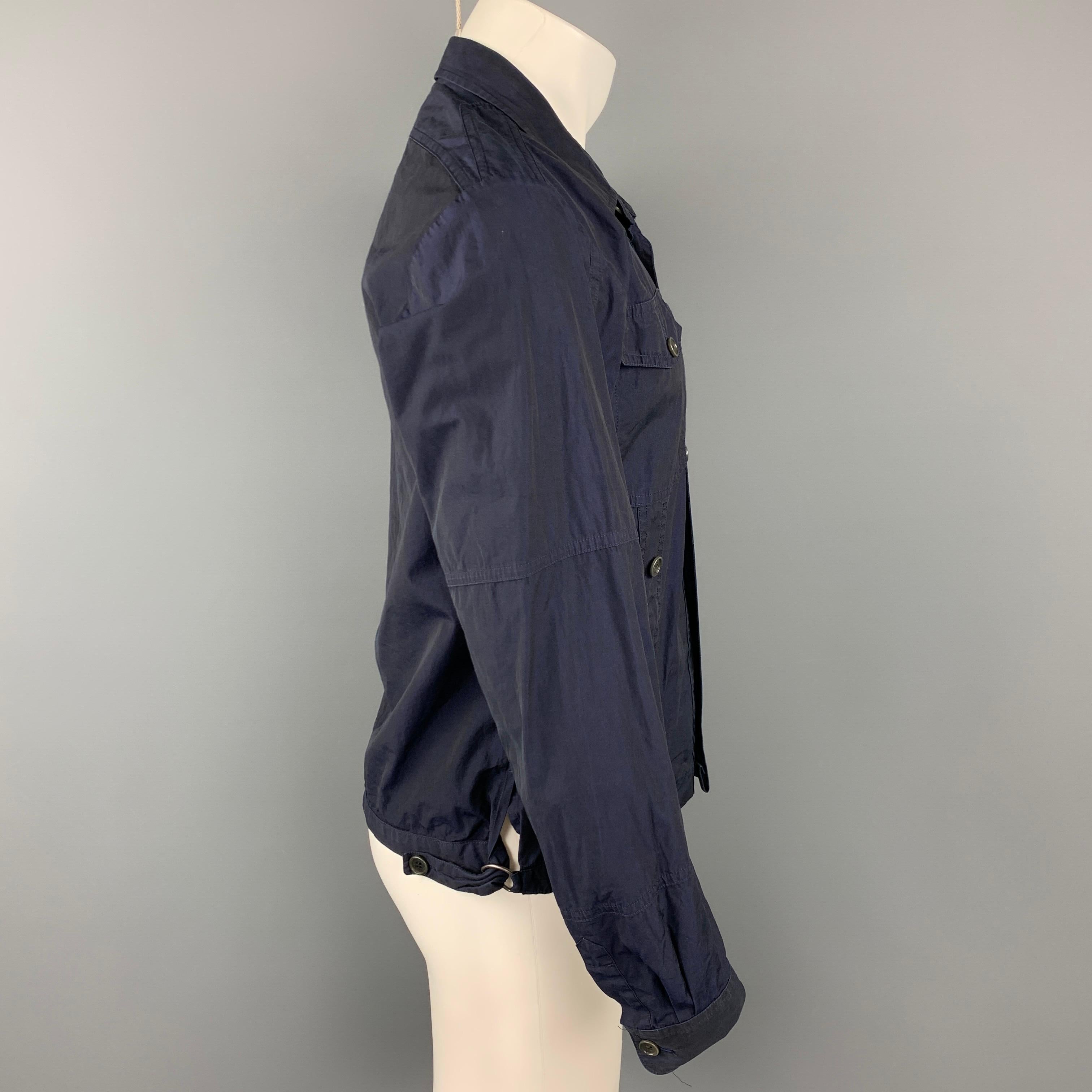 DRIES VAN NOTEN jacket comes in a navy cotton featuring a trucker style, patch pockets, spread collar, and a buttoned closure. Made in Romania.

Good Pre-Owned Condition.
Marked: 50

Measurements:

Shoulder: 17.5 in.
Chest: 40 in.
Sleeve: 26.5