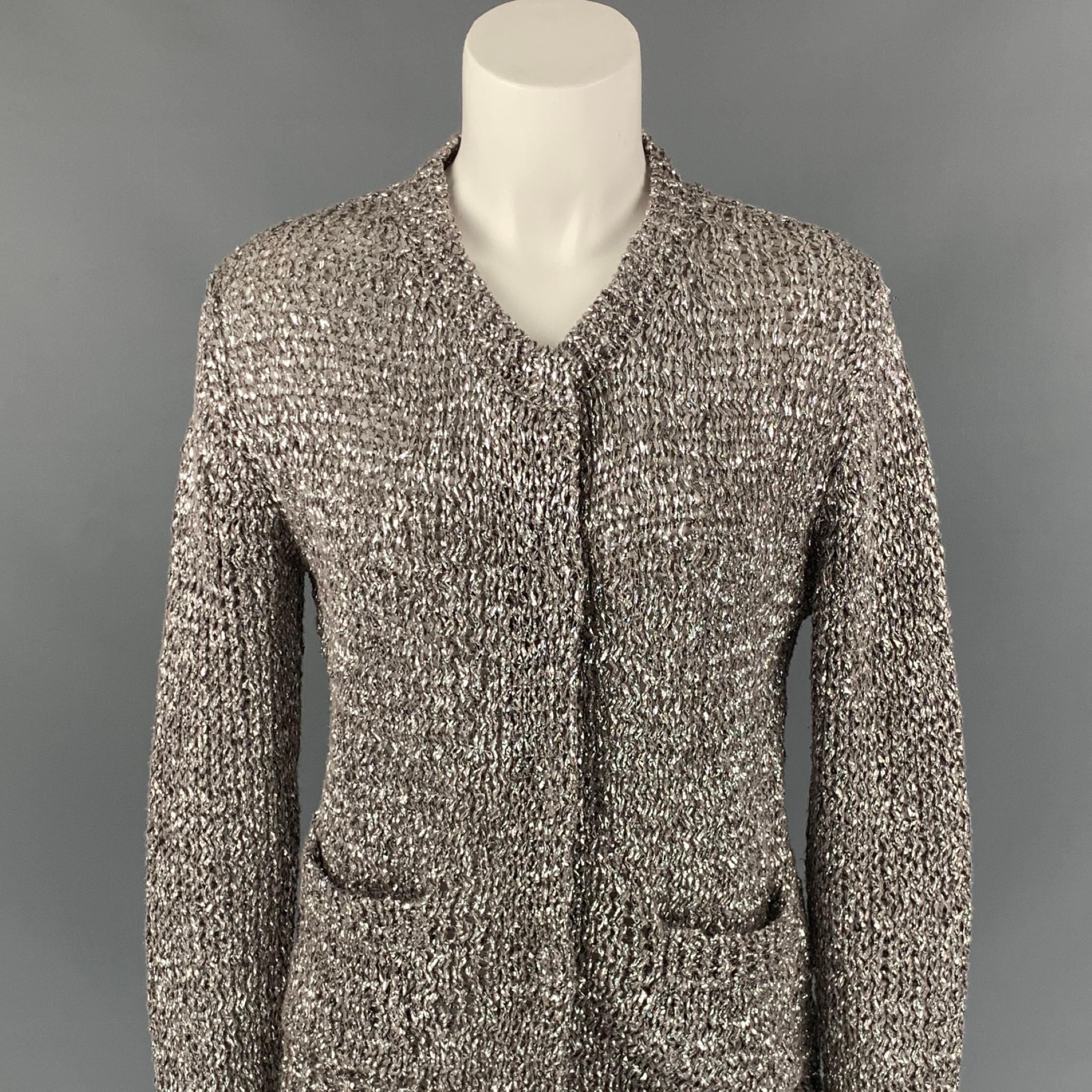 DRIES VAN NOTEN cardigan comes in a silver metallic knitted cotton / polyester featuring front pockets and a hidden snap button closure. Made in Belgium.

Very Good Pre-Owned Condition.
Marked: M

Measurements:

Shoulder: 16 in.
Bust: 36 in.
Sleeve: