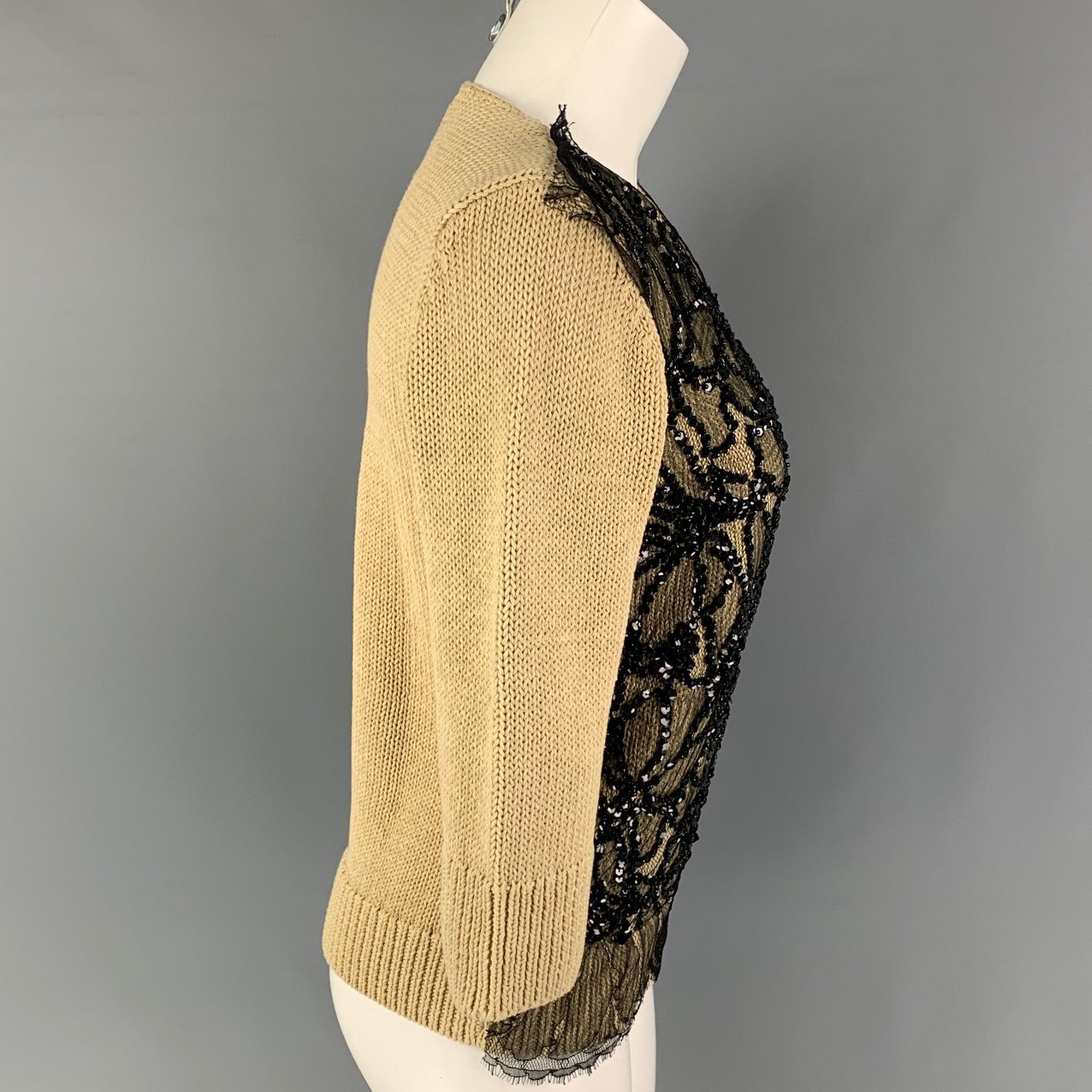 DRIES VAN NOTEN pullover comes in a beige knitted cotton with a front black lace sequined panel featuring 3/4 sleeves and a crew-neck.
Very Good
Pre-Owned Condition. 

Marked:   S 

Measurements: 
 
Shoulder: 15.5 inches  Bust: 34 inches  Sleeve: