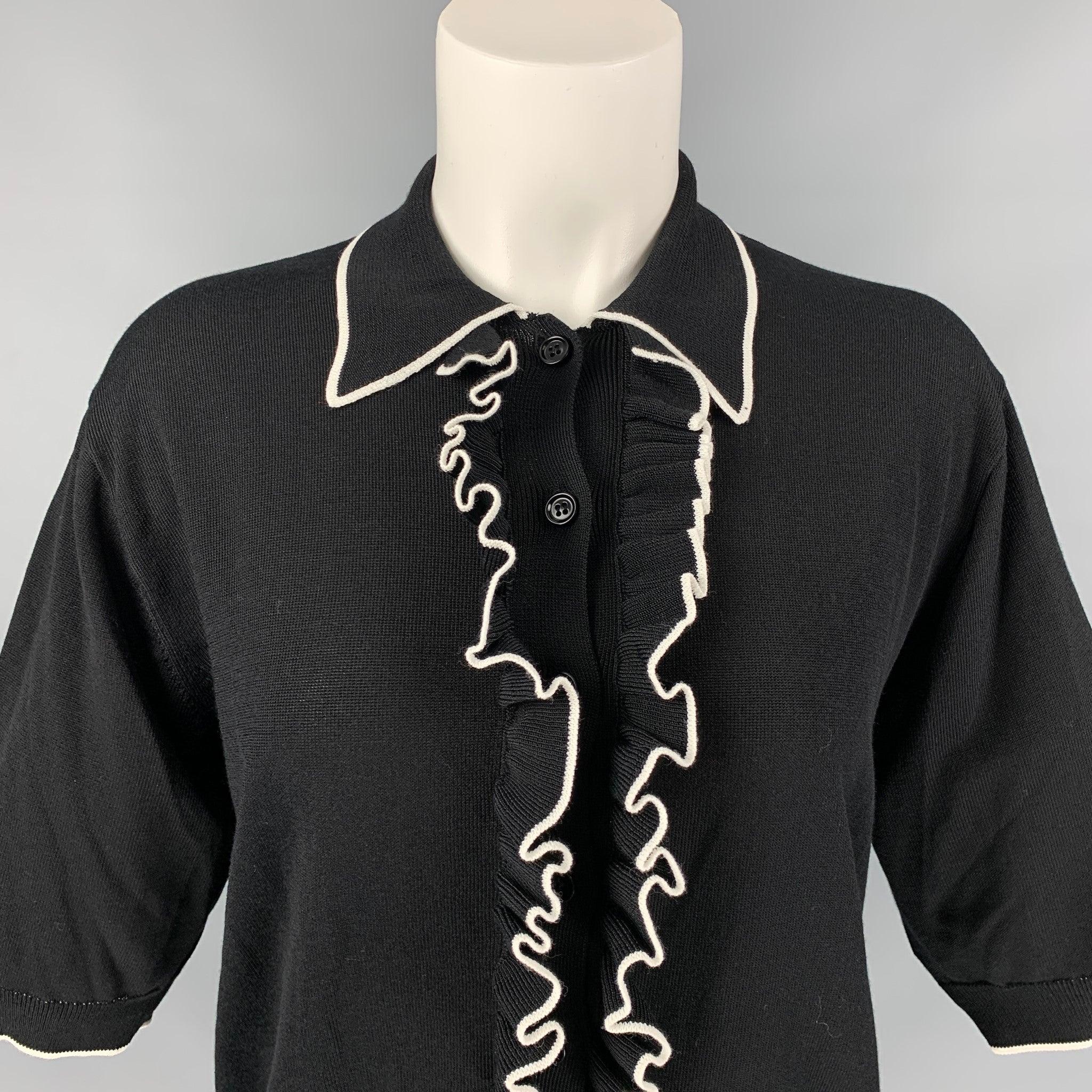 DRIES VAN NOTEN polo shirt comes in a black & white viscose / cotton featuring a ruffled trim, pointed collar, and a buttoned closure.
Excellent
Pre-Owned Condition. 

Marked:   S 

Measurements: 
 
Shoulder: 17 inches  Bust: 36 inches  Sleeve: 12