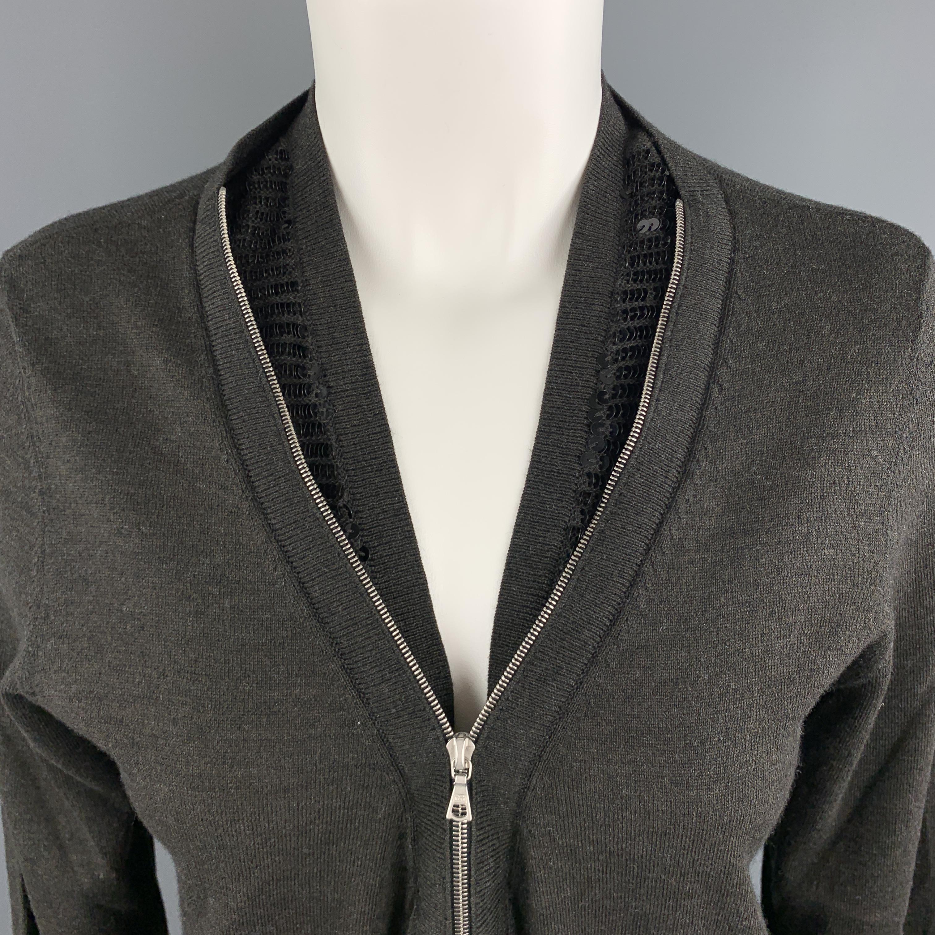 DRIES VAN NOTEN cardigan comes in charcoal wool blend with a sequin inner collar neckline and zip front. Made in Belgium.

Excellent Pre-Owned Condition.
Marked: Small

Measurements:

Shoulder: 16 in.
Bust: 40 in.
Sleeve: 24 in.
Length: 23 in.