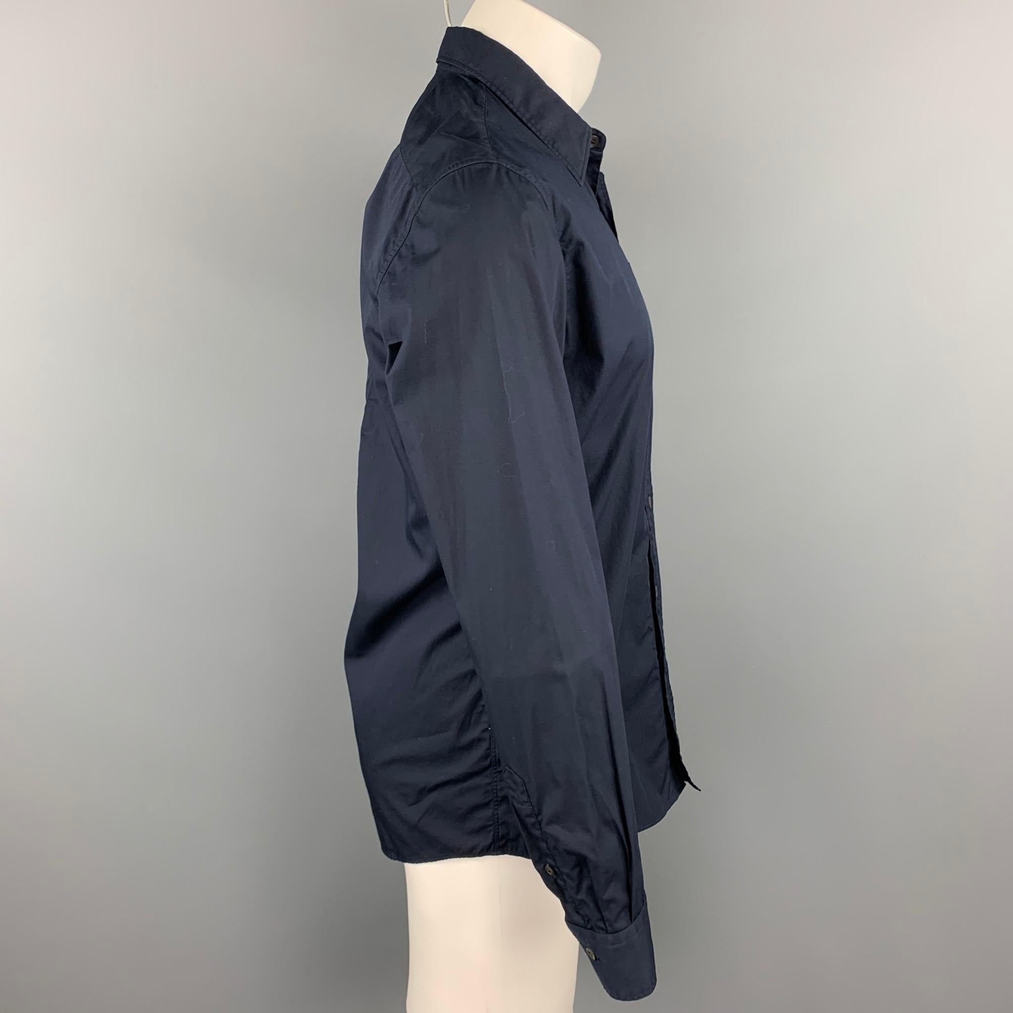 DRIES VAN NOTEN ong sleeve shirt comes in a navy cotton featuring a button up style, front pocket, and a spread collar. 

Very Good Pre-Owned Condition.
Marked: 48

Measurements:

Shoulder: 18 in.
Chest: 40 in.
Sleeve: 26 in.
Length: 30 in. 
