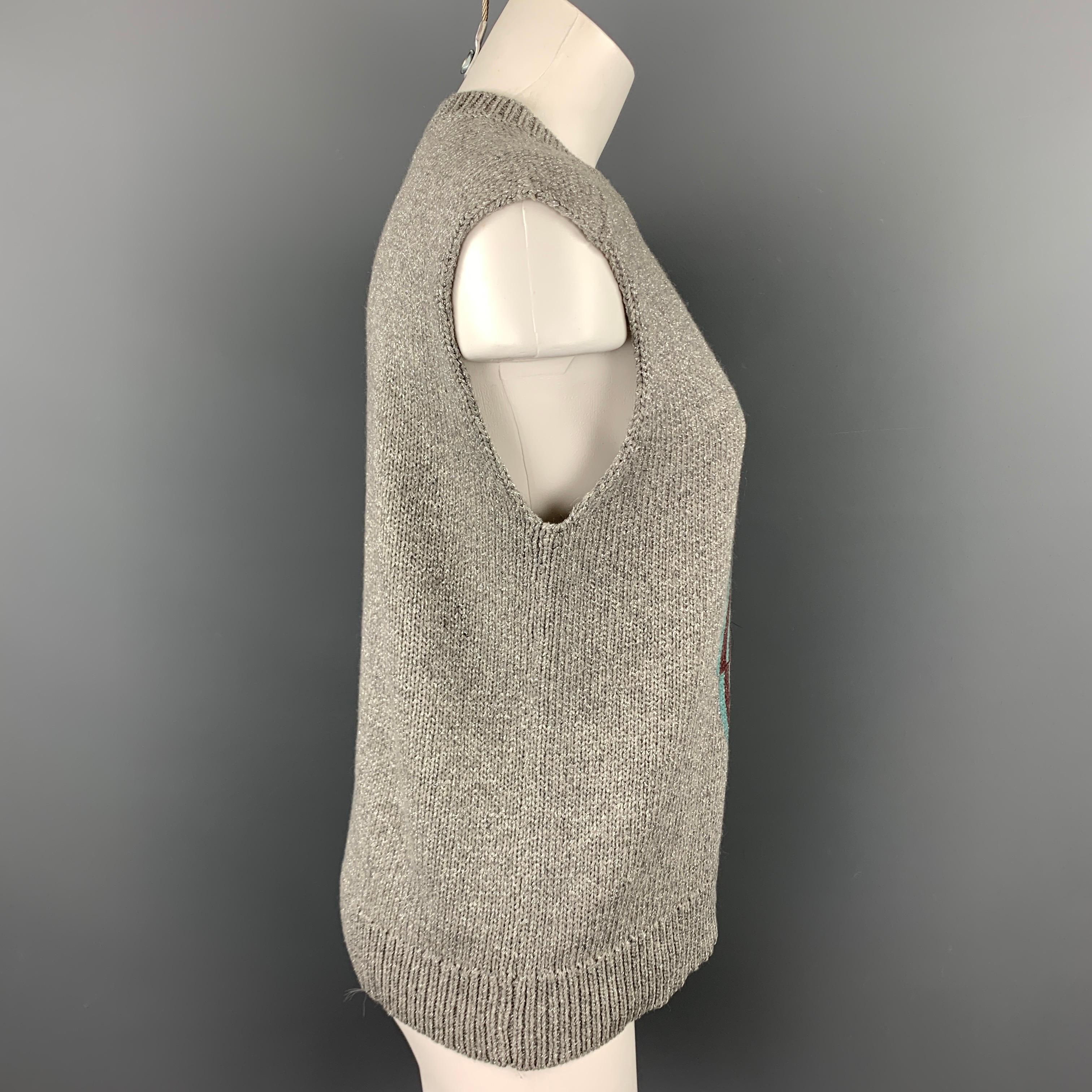 DRIES VAN NOTEN vest comes in a silver knitted geometric wool blend featuring a ribbed crew-neck.

Very Good Pre-Owned Condition.
Marked: S

Measurements:

Shoulder: 16.5 in. 
Bust: 38 in. 
Length: 23 in. 
