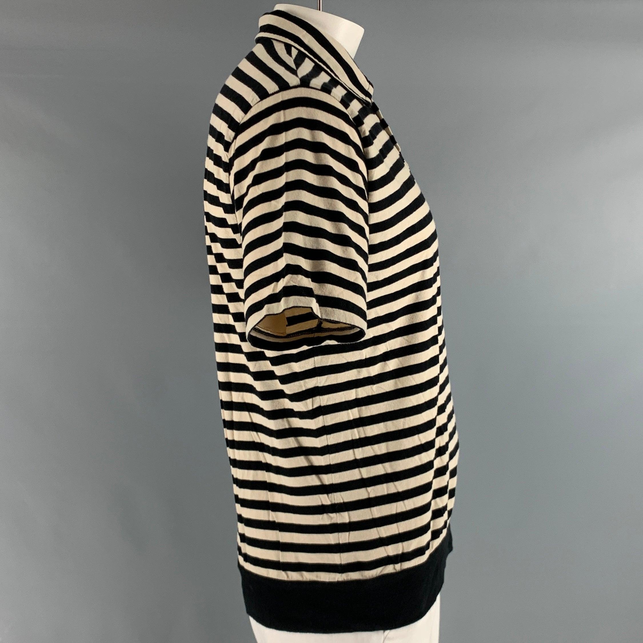 DRIES VAN NOTEN polo in a black and white jersey cotton knit material featuring horizontal stripe pattern, and half placket button closure.Very Good Pre-Owned Condition. Minor pilling. 

Marked:   XL 

Measurements: 
 
Shoulder: 19 inches Chest: 48