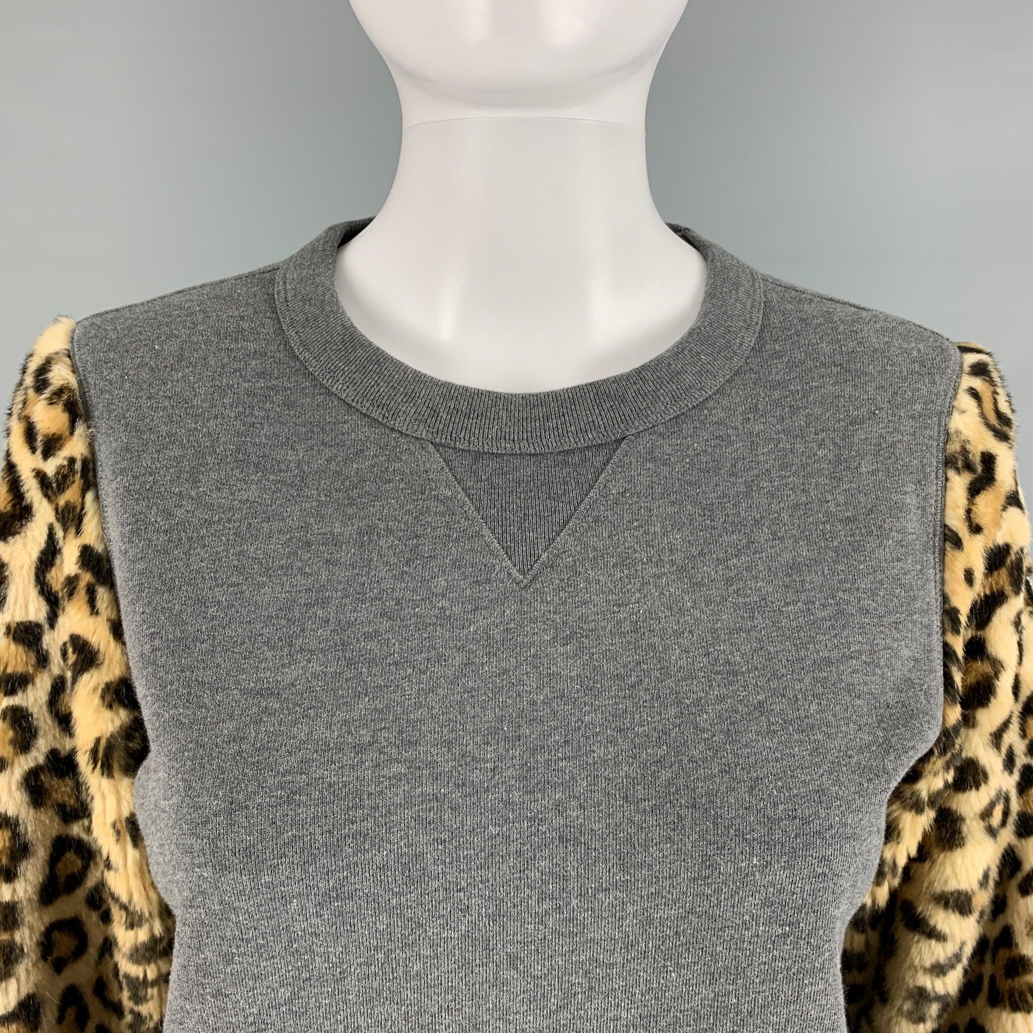 DRIES VAN NOTEN sweater comes in a heather grey french terry knit material featuring animal print faux fur sleeves, and a ribbed crew-neck. Excellent Pre-Owned Condition. 

Marked:   Extra Small 

Measurements: 
 
Shoulder: 15 inches  Chest: 37