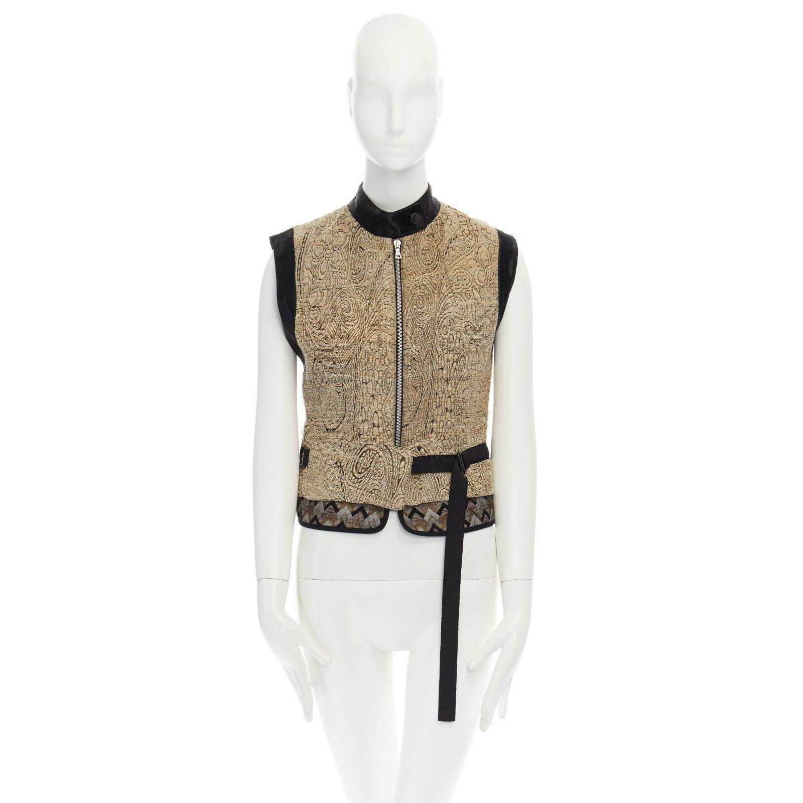 DRIES VAN NOTEN SS15 gold ethnic embroidered brocade harness vest top FR36 S
DRIES VAN NOTEN
FROM THE SPRING SUMMER 2015 COLLECTION
SILK, COTTON, ACRYLIC, POLYAMIDE, POLYESTER. 
BEIGE ORIENTAL EMBROIDERED BROCADE. ETHNIC CHEVRON JACQUARD AT HEM.
