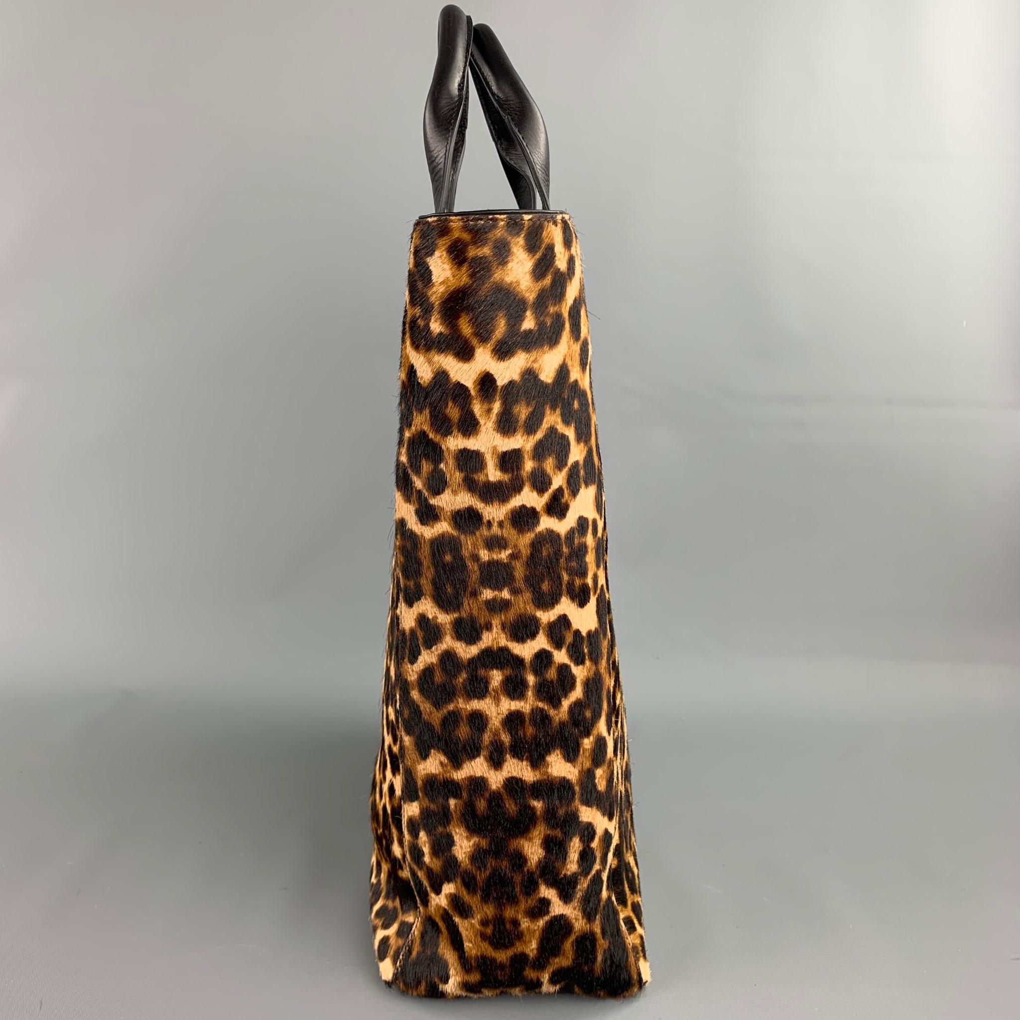 DRIES VAN NOTEN tote bag comes in a tan & black animal print pony hair with a leather trim featuring top handles, shoulder strap, and a inner pocket.

New With Tags.

Measurements:

Length: 11.5 in.
Width: 5 in.
Height: 14 in.
Drop: 15 in.  