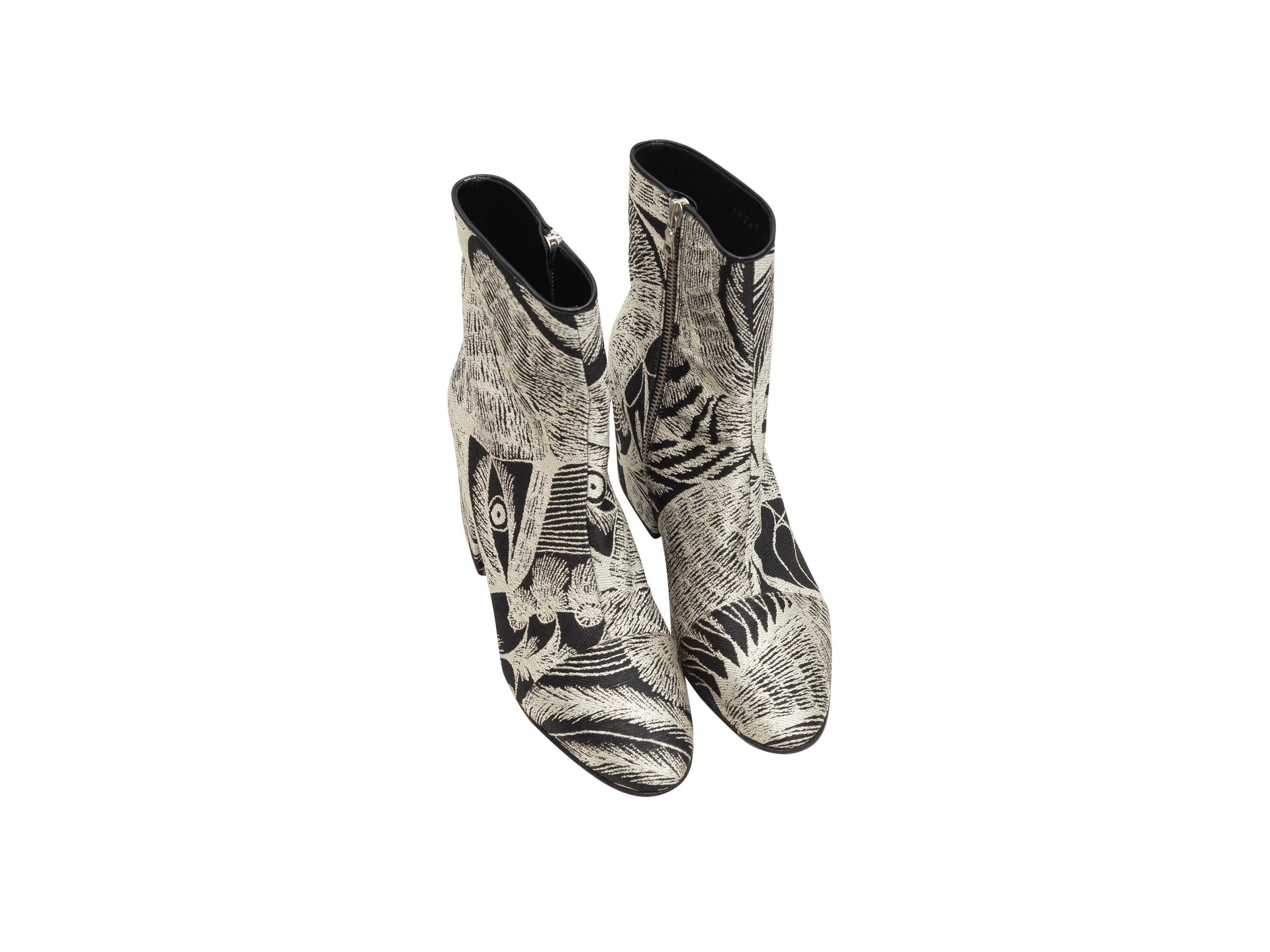 Product details: White and black jacquard ankle boots by Dries Van Noten. Abstract pattern throughout. Block heels. Zip closures at inner sides. Designer size 40. 3.25