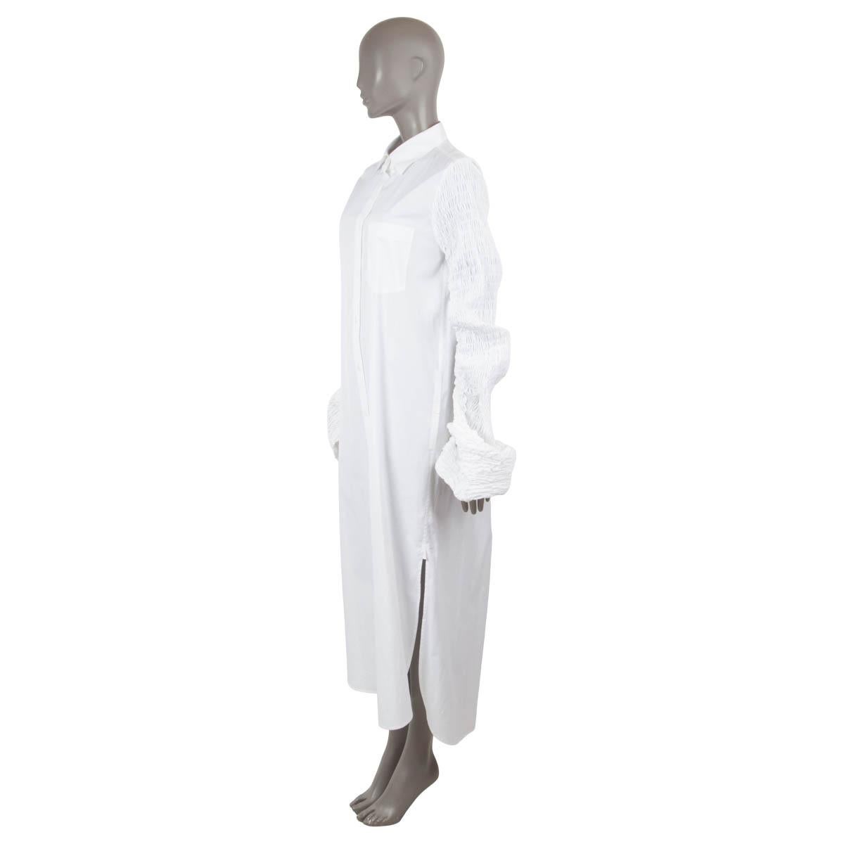 100% authentic Dries Van Noten classic poplin maxi shirtdress with long flared smocked sleeves in white cotton (100%). The design features a point collar, button front closure, a chest patch pocket, back box pleat, buttoned side slits and side split