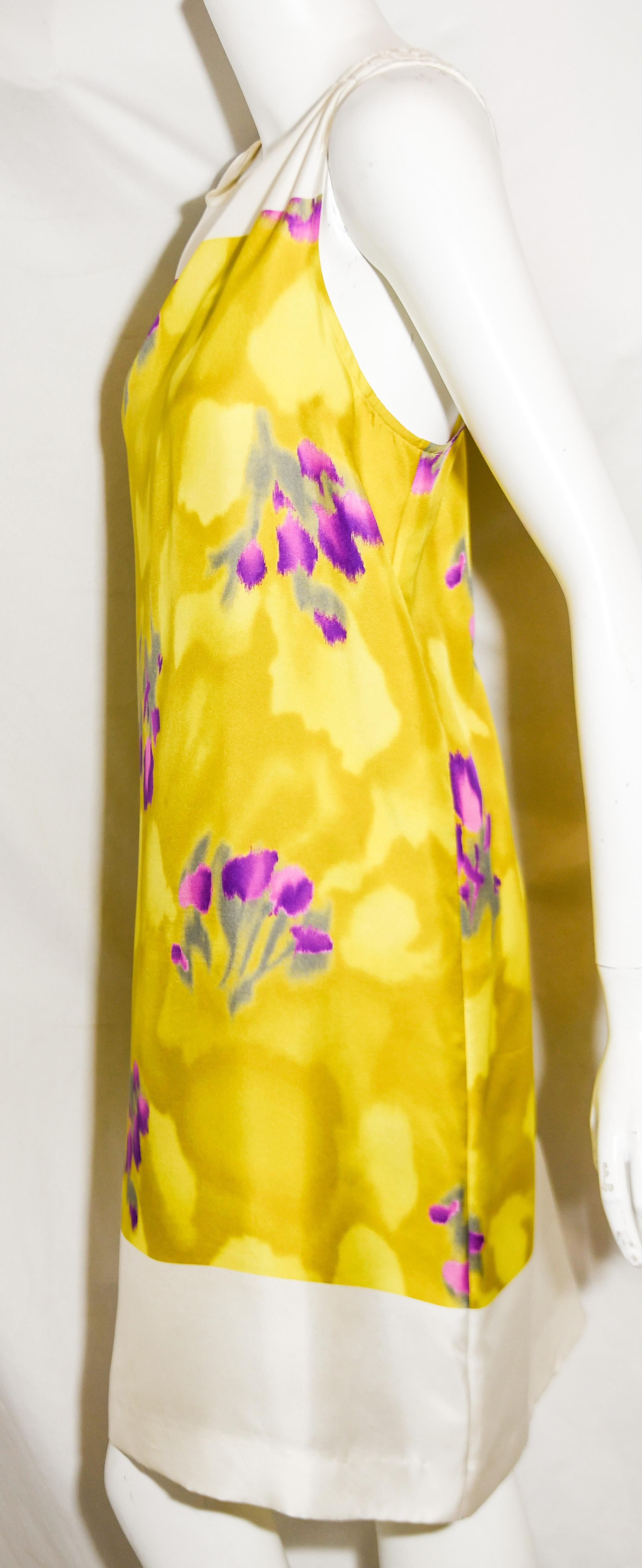 Dries Van Noten white and yellow floral dress includes a round neckline and in the color block style to the bust, also, at the hem, in white silk.  This dress is lined in white silk.   For closure, a zipper at back.  Dress is in excellent condition.