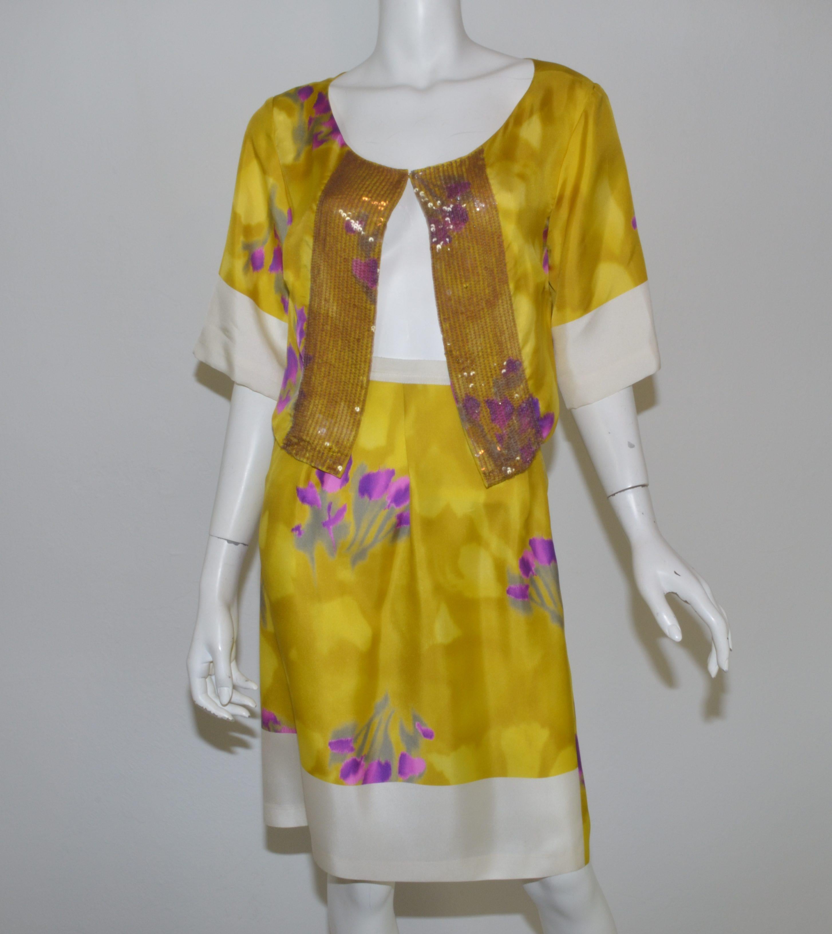 Dries Van Noten skirt set is featured in beautiful yellow and purple silk with a floral print throughout the fabric. Top has a single hook and eye closure with sequin embellishing along the opening. 100% silk, in excellent