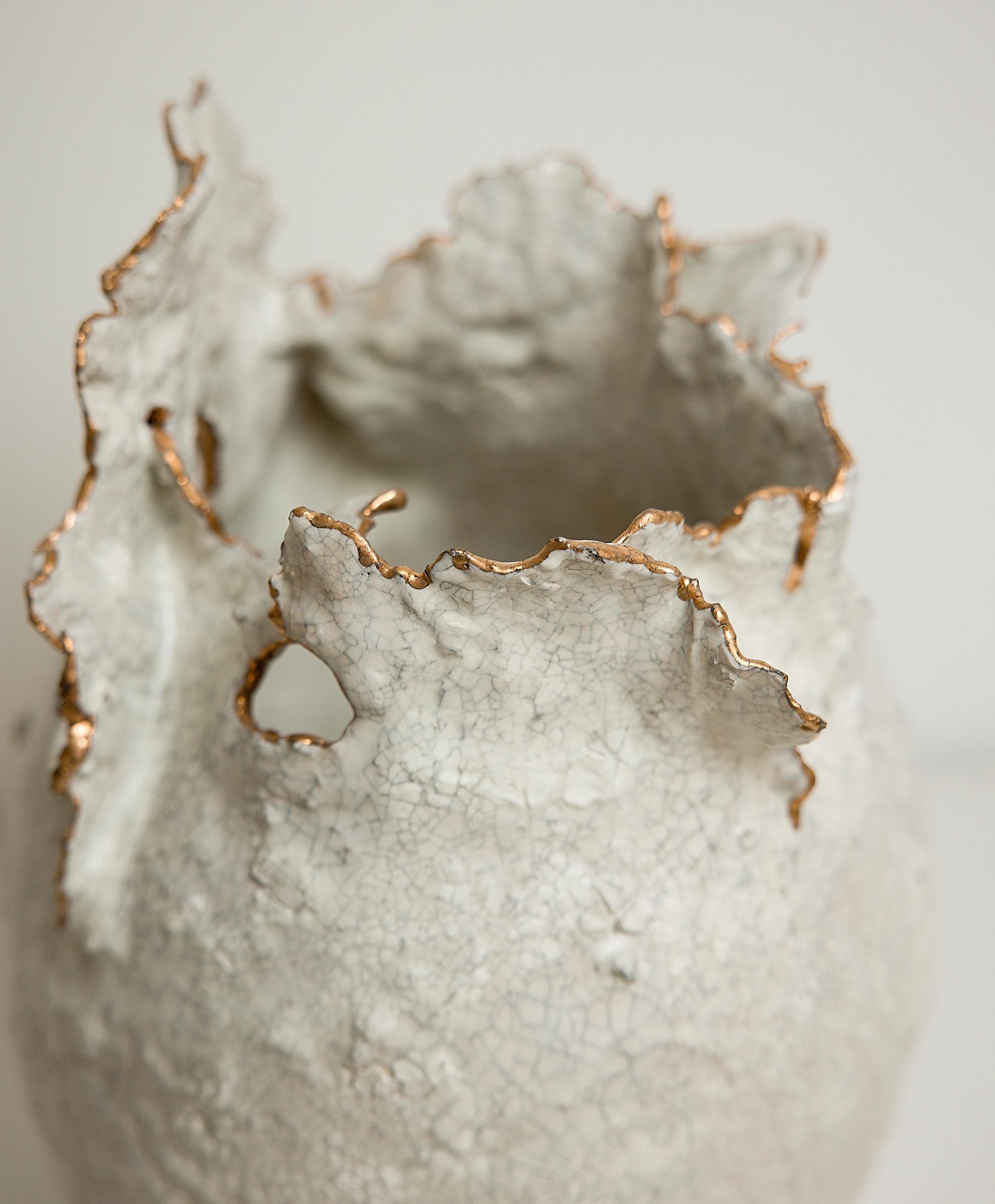 Bring a touch of modern style to your home with our Drift Torn Edge Vases
one of kind 
this White open  jar with Textured drips and lava glaze
one of a kind
with the brilliance of 22-karat yellow gold

., each striking vase features a unique,