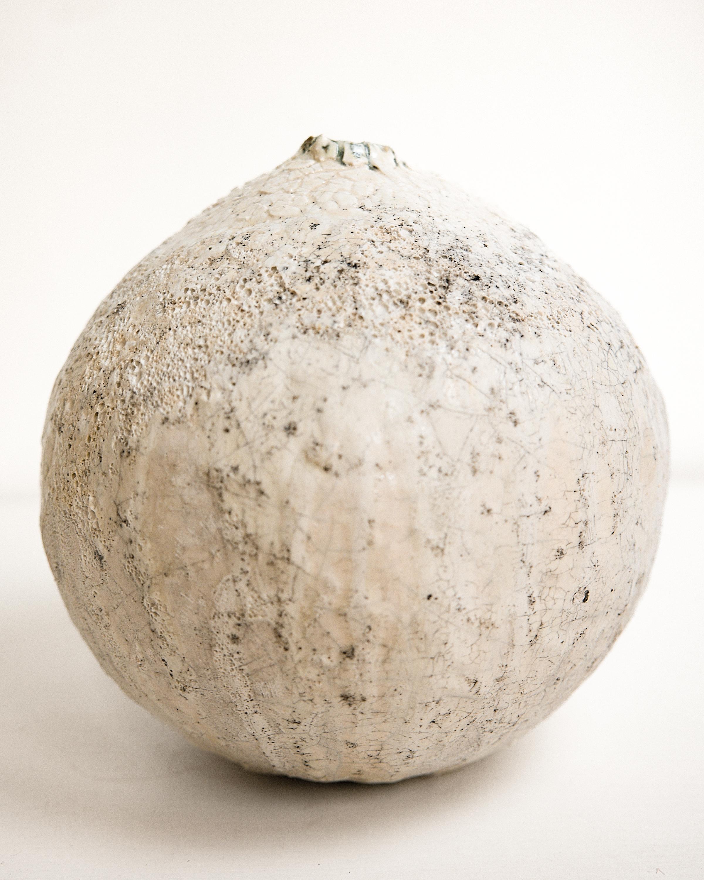 Bring a touch of modern style to your home with our Cream texture Moon vases
one of kind 
this White moon jar with Textured drips 
 Matt glaze 
one of a kind

., each striking vase features a unique, moon-like design in an eye-catching light lava