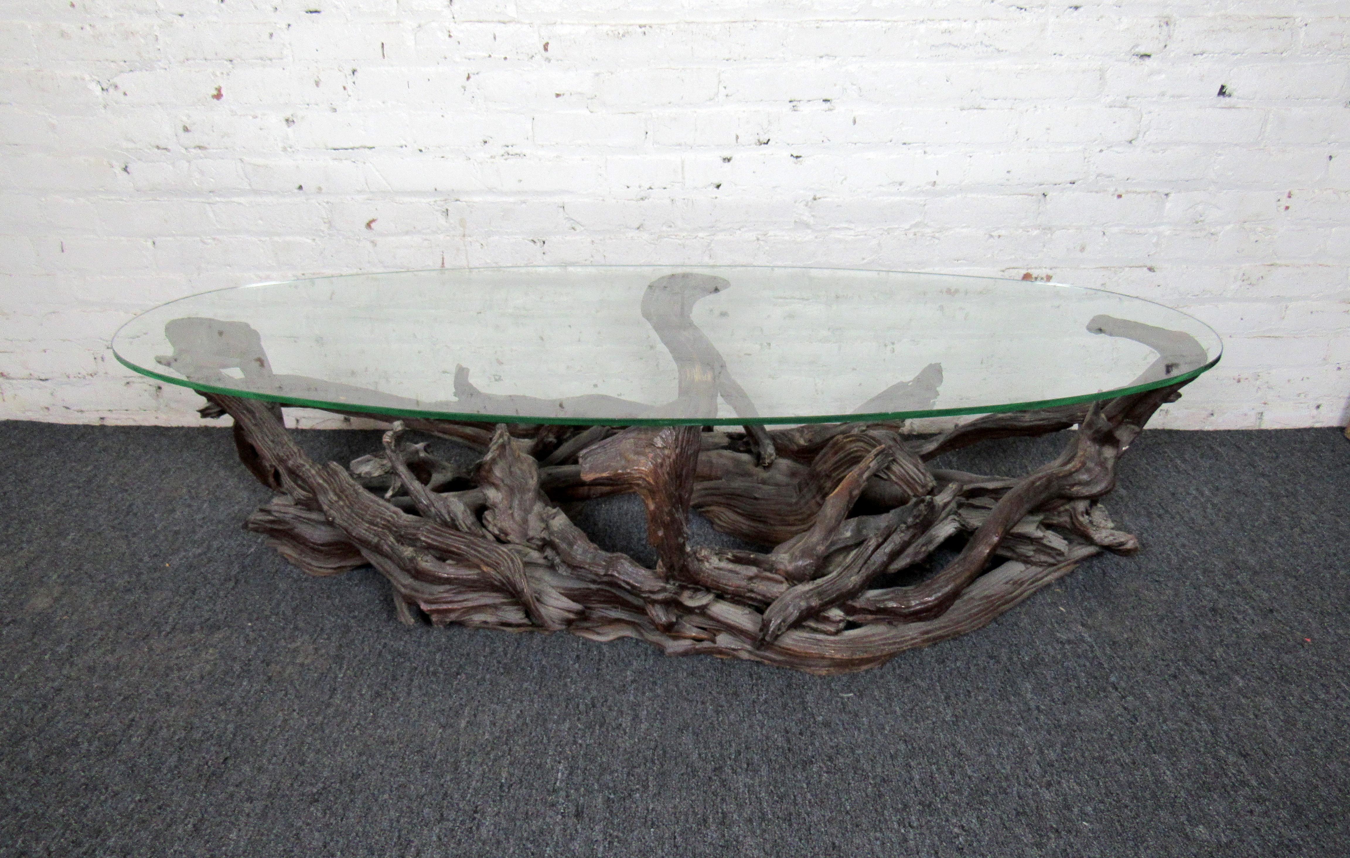 This one-of-a-kind coffee table features a base of intertwined driftwood and a glass top for a unique look. The well-preserved wooden base brings a small piece of nature into any home or space. 

Please confirm the item location (NY or NJ).
 