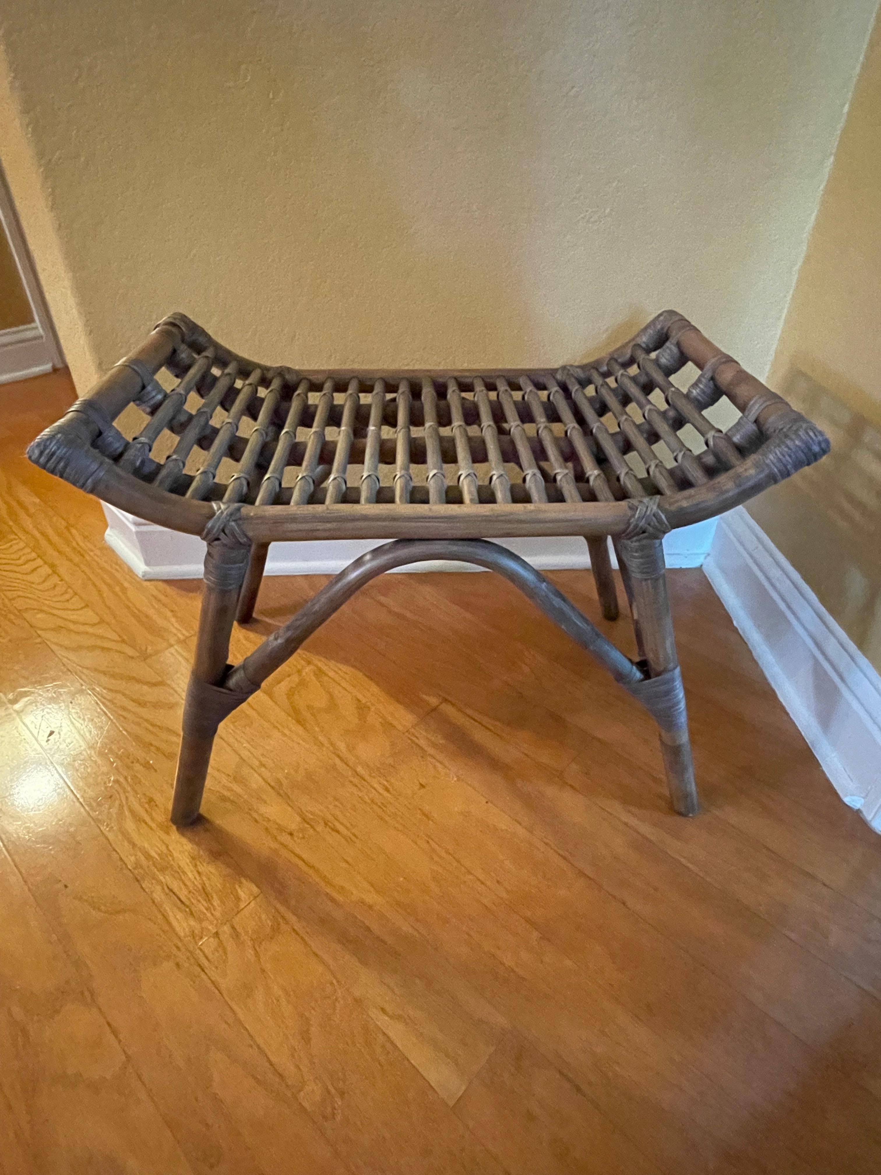 This is an unusual and terrifically versatile piece. It's made entirely of bamboo (probably European-produced bamboo) and held together with rattan roping. It's in great condition, and is structurally sound.  it's driftwood-colored stain give it an