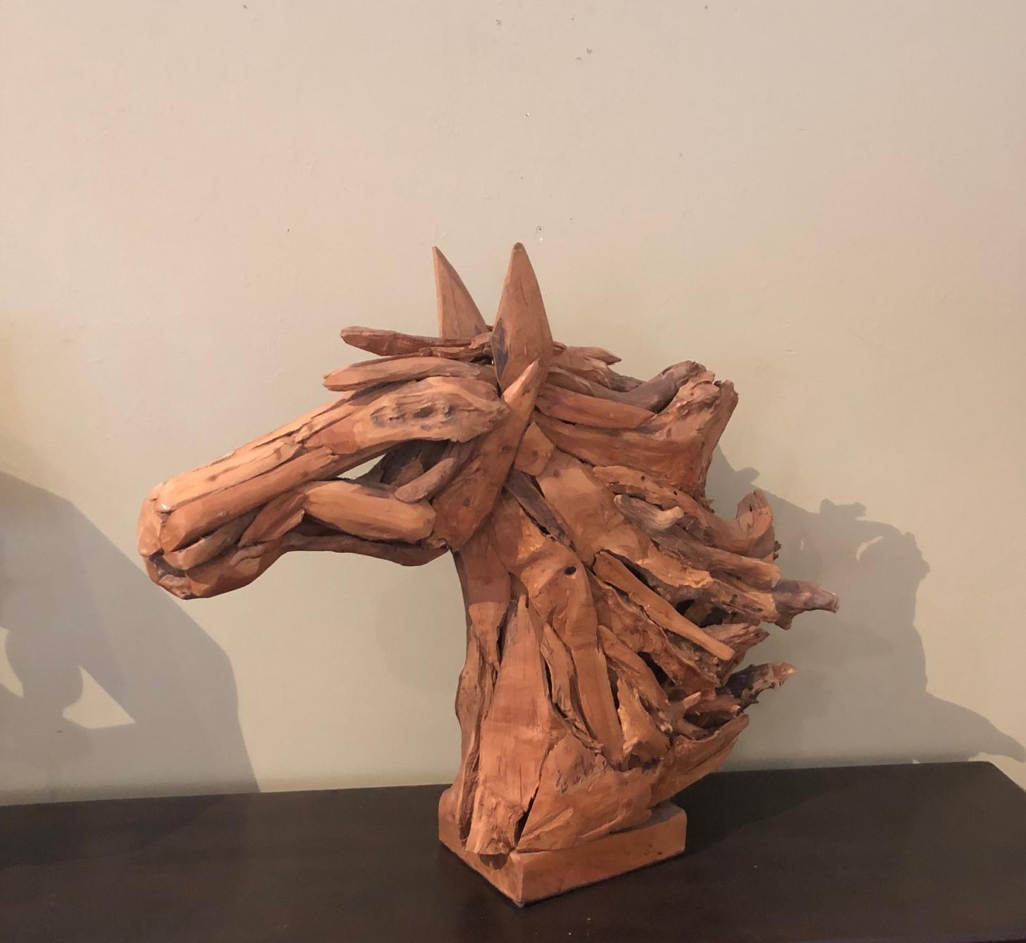 Stunning driftwood and reclaimed wood horse head sculpture, circa 1970s. The large statement piece has been intricately crafted and sits on a wood block base.