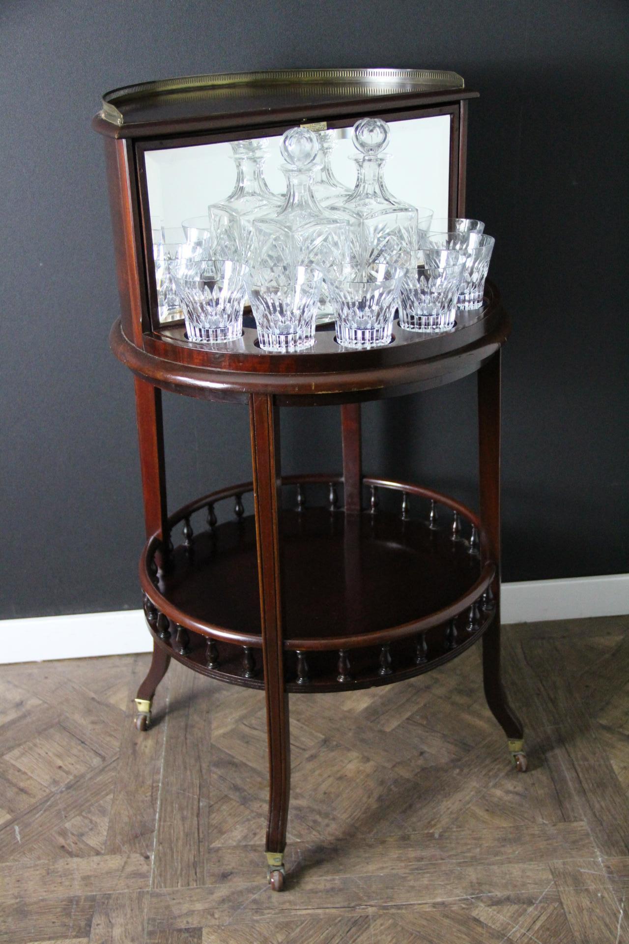 This English drink cabinet is particularly unusual and elegant.
From 1920's , Its drink compartment spins over to reveal on one side a breathtaking interiors made of a full set of 6  Baccarat glasses and two Saint Louis Crystal decanters and a kind