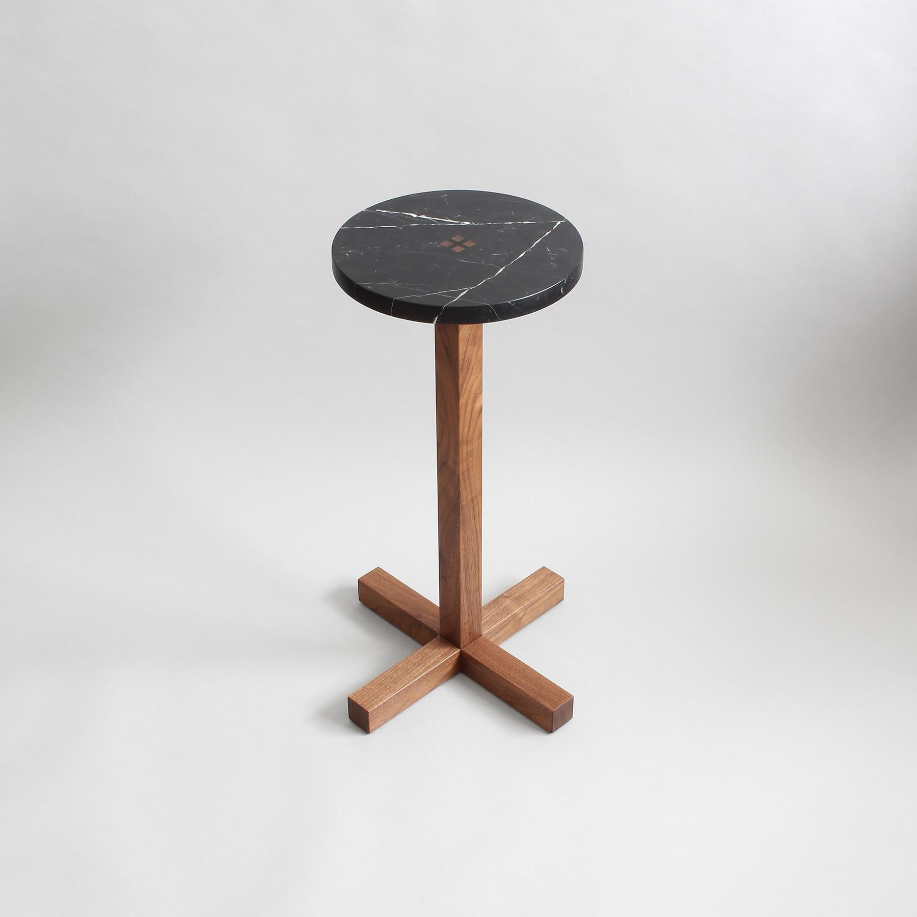 Drink Table with black marble top joined to a solid walnut base. Ebony wedges at center table top are driven permanently into place to combine stone top with wood base. The wood base is constructed with traditional Japanese joinery for structure