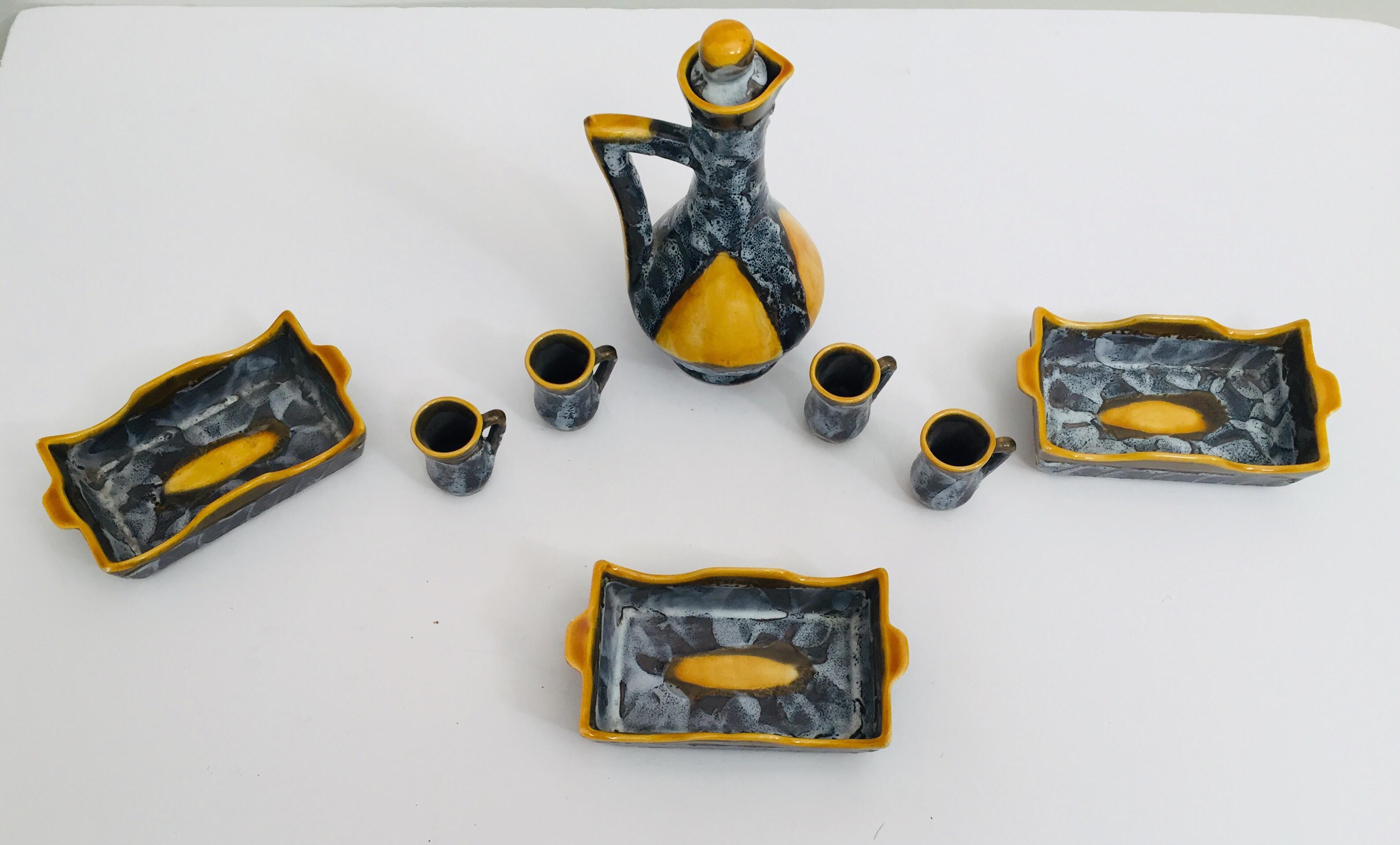Vallauris Beautifully handcrafted ceramic drinking set in vibrant combination of colors for this great set with one pitcher pitcher, three rectangular shape bowls and six cups.
A stylish vintage midcentury French hand painted Vallauris pottery set