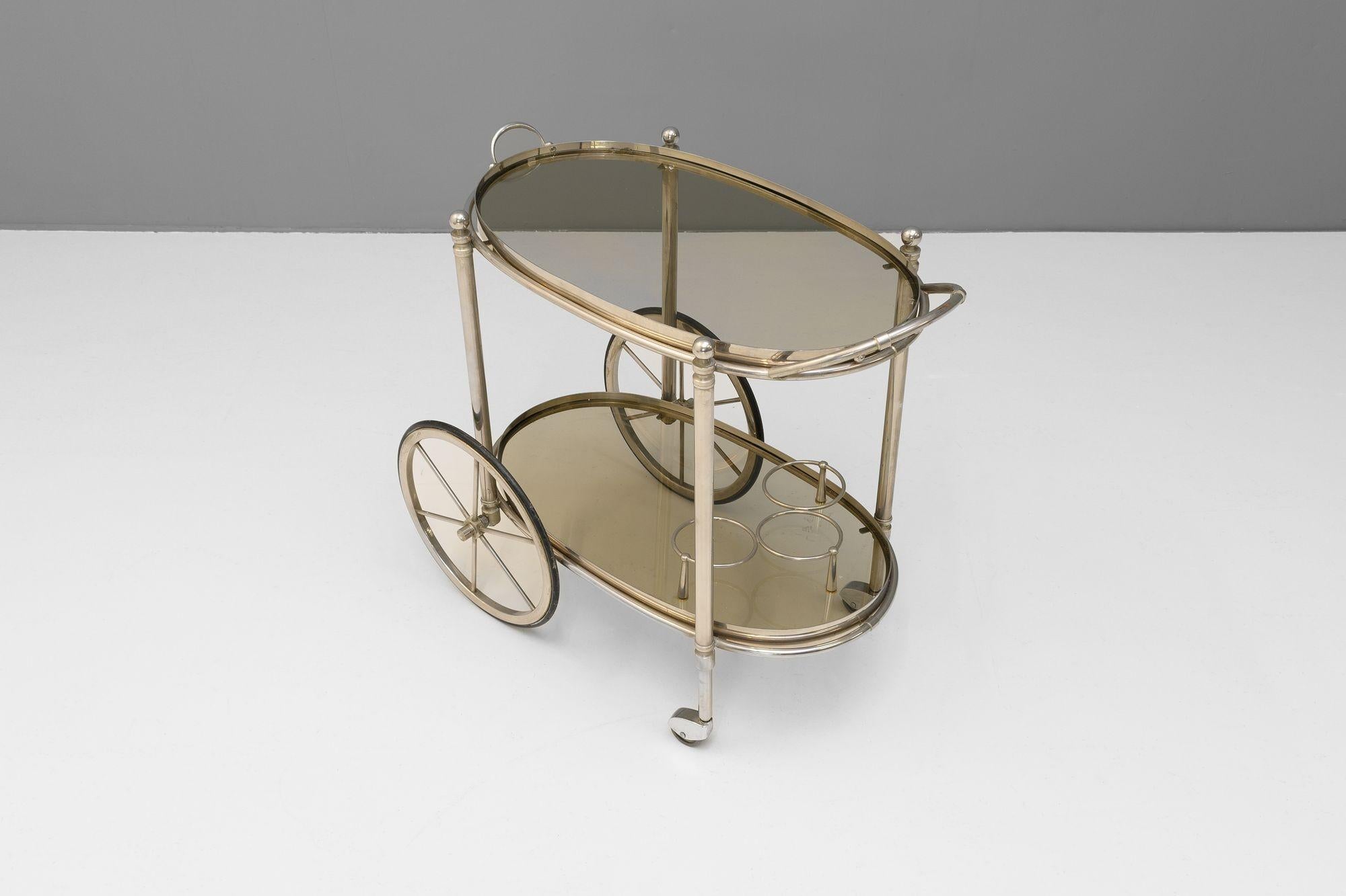 Two tier plated drinks trolley with original grey glass shelves. Circa 1930
H 66cm x W 48cm x D 72cm