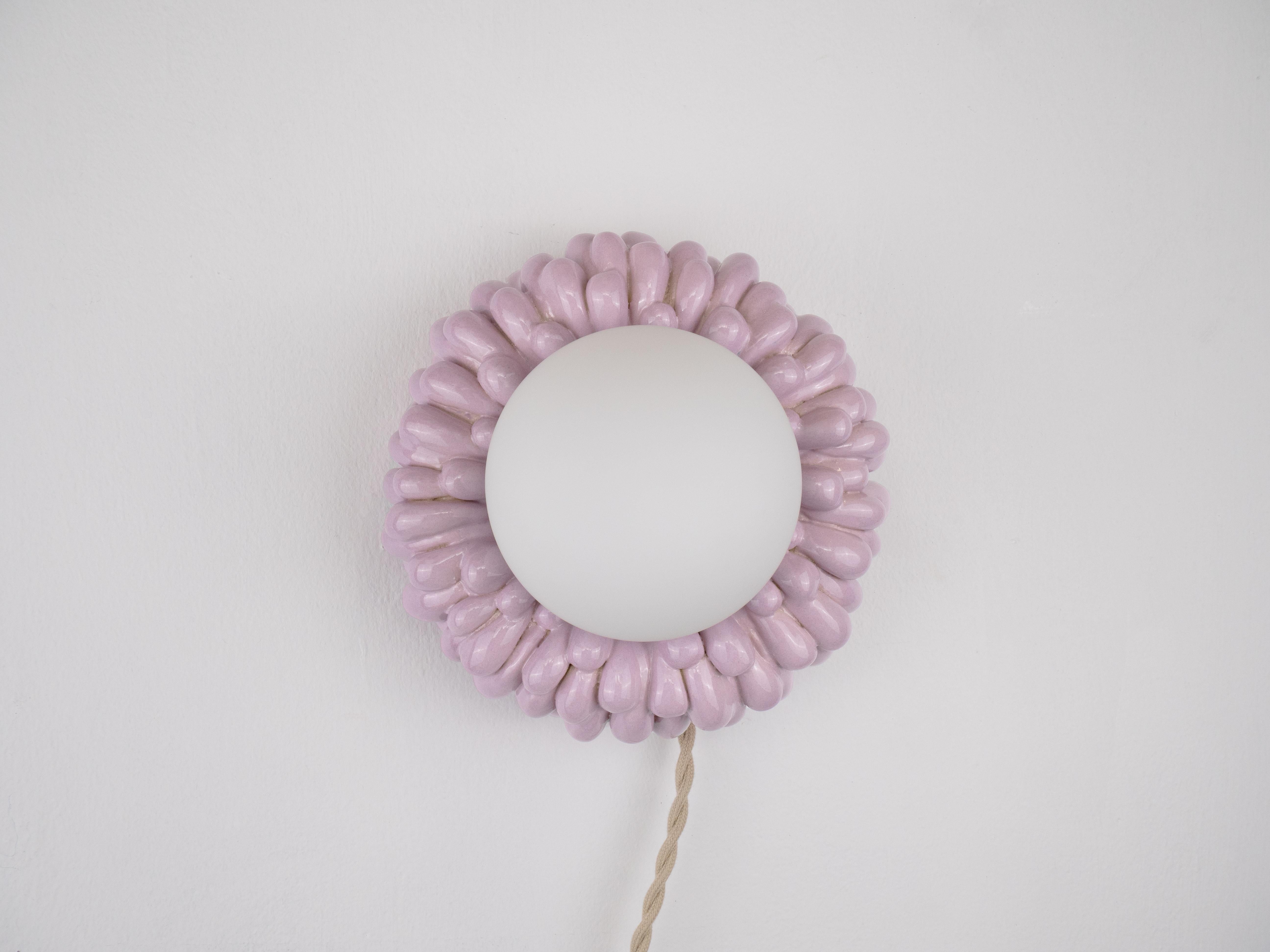 This hand-crafted ceramic wall light has the cutest flower-like design with a glowing centre that will add a warm touch to any space. With its delicate, glossy drips, it’s a fun mix of quirky and stylish.

Bulb is included
Bulb fitting: G9
Glass