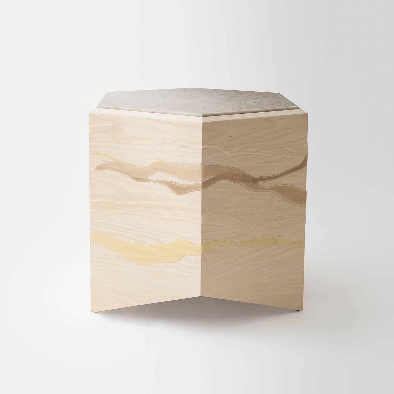 This Drip/Fold side table by Noble Goods is constructed of a single sheet of ash plywood that has been hand-dripped with liquid resin, then bent into a hexagonal shape. This floor model table is finished with a quartzite top, a unique and natural