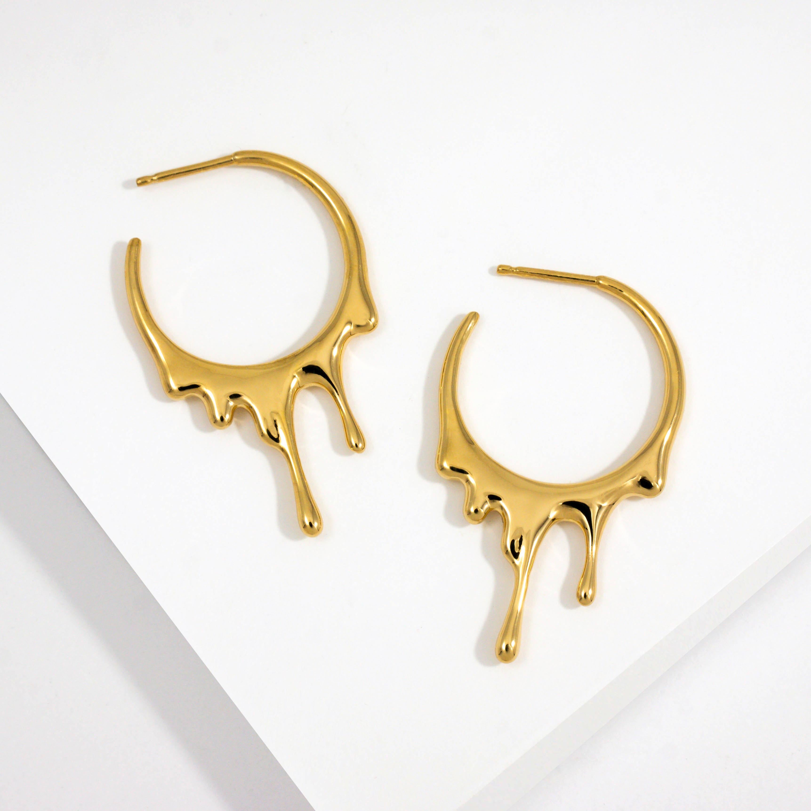 Dripping Circular S  Gold  Earrings

24k Gold Vermeil: Made in 925 Sterling Silver and coated with a thick layer of 24k Yellow Gold to 2.5 Microns thickness

Sold as a Pair with Butterfly and Silicone Earring Backs

Approximately 37mm (1.5in) High