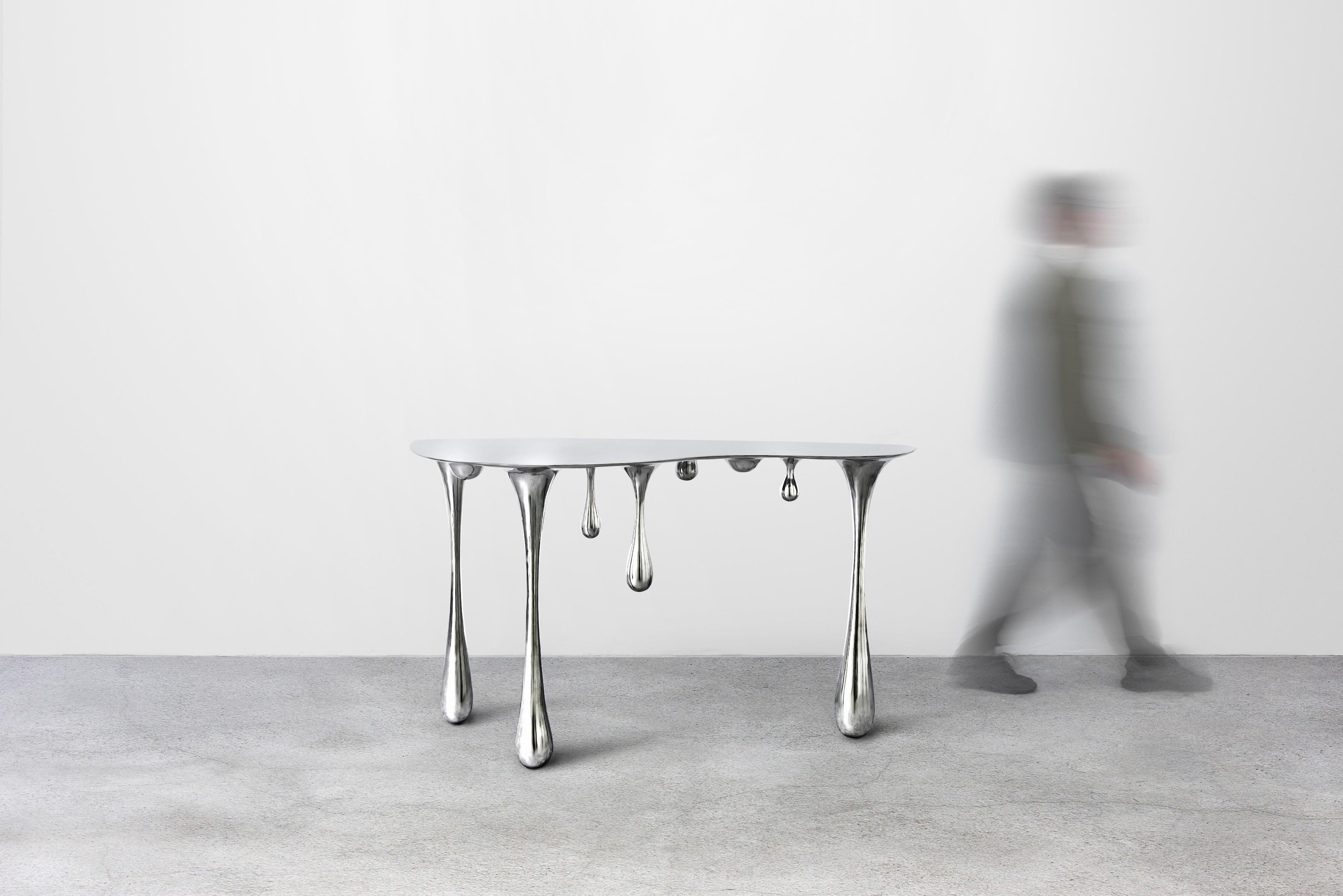 The table is made in polished stainless steel and is customizable upon request. Lead time is 30-45 days for current design and up to 75 days for custom piece. 

The artist Zhipeng Tan is a self-taught sculptor with an Industrial Design degree from
