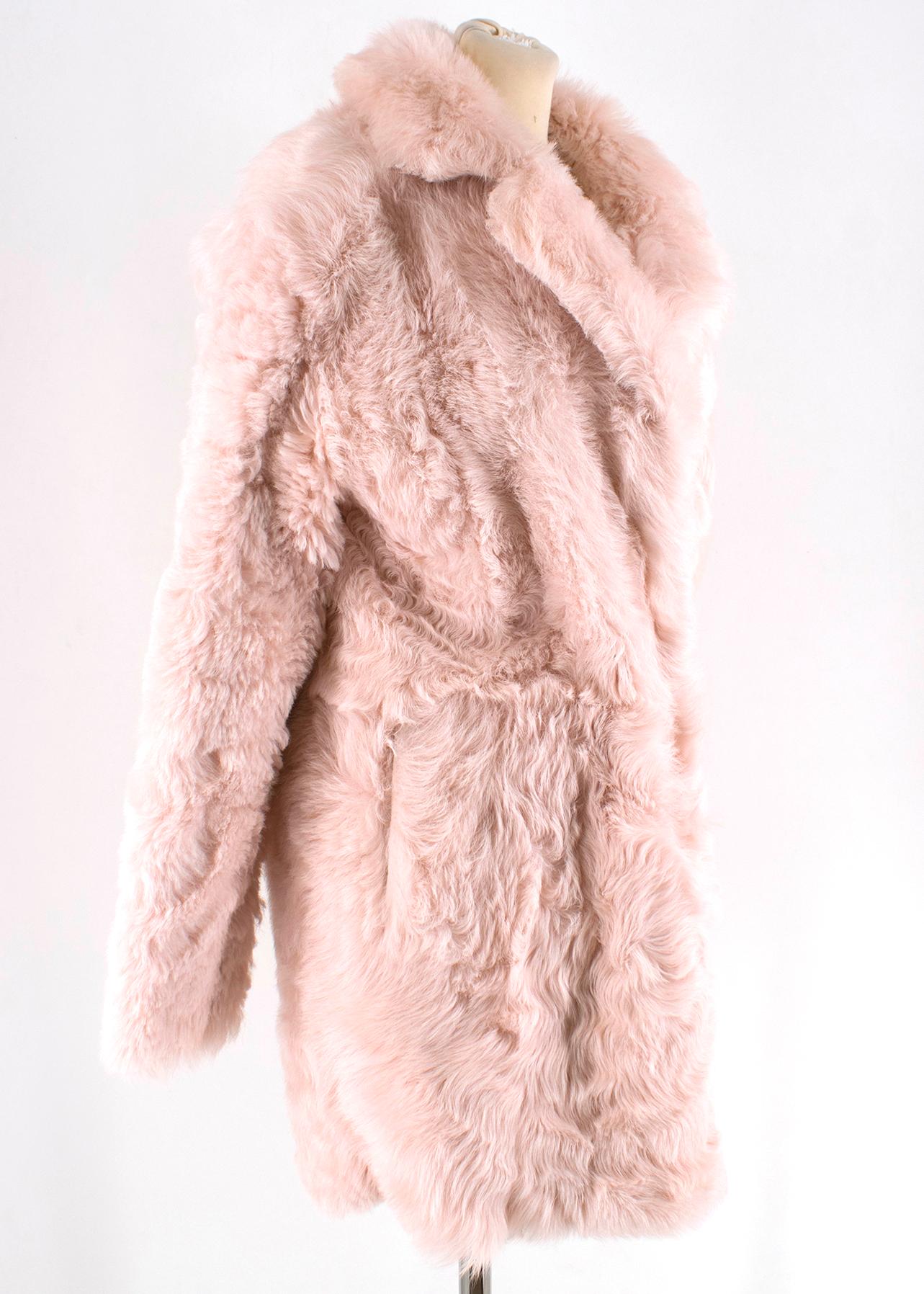 Drome Pink Double Breasted Reversible Shearling Coat

-Pink reversible coat
-Two pockets on interior and exterior sides
-Heavy weight material
-Snap fastening closures
-Lamb Suede & Lamb shearling sides
-Long sleeves
-Notched collar 
-Oversized