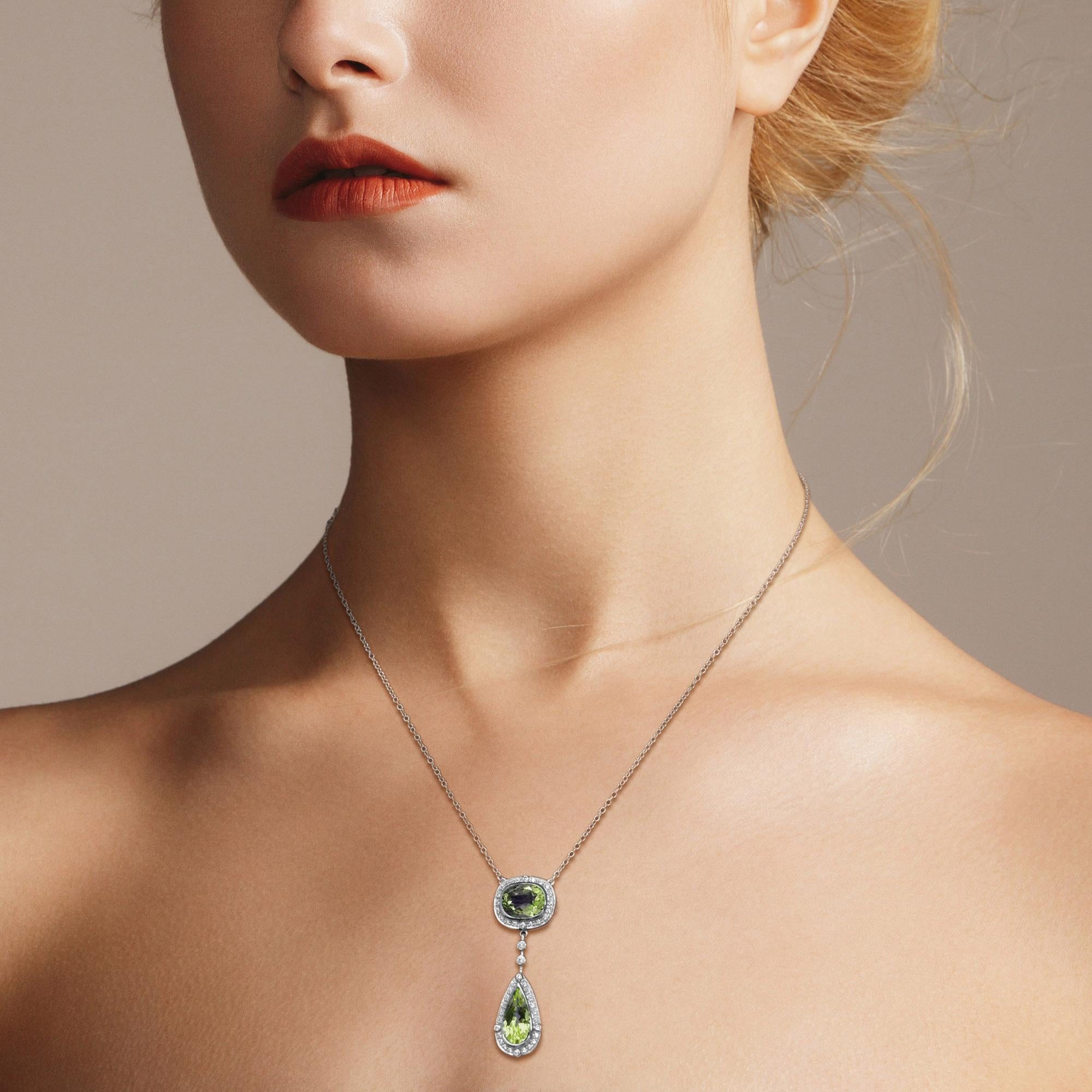Create a stunning and adorable look with this double-drop peridot and diamond accent necklace! Cut to the mesmerizing, faceted cushion and pear shape. Adding to the stunning design, 0.37 carat round diamonds beautifully outline the focus gemstones.