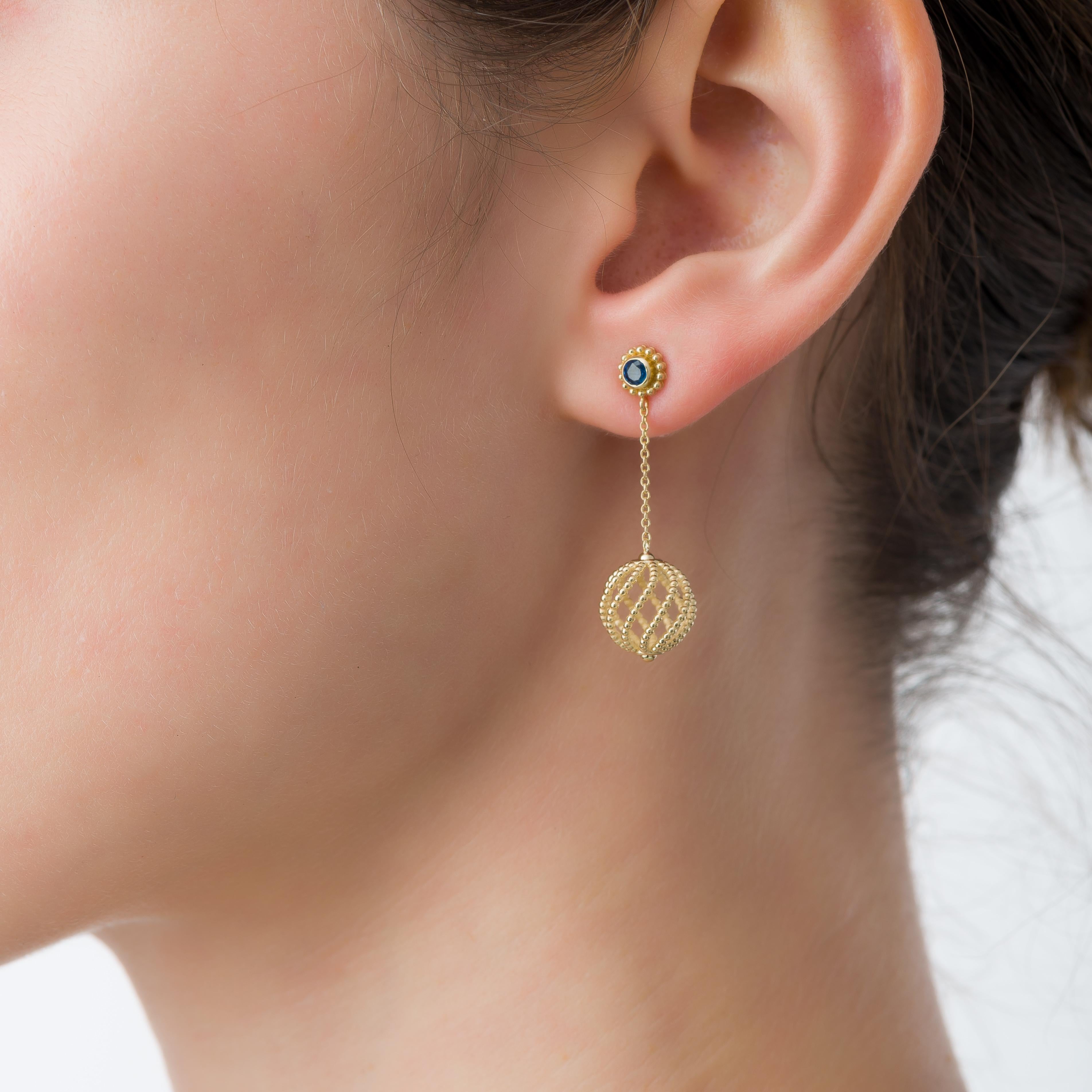 Grace your ears with these exquisite gold drop earrings, delicately handcrafted in an open ball shape adorned with intricate granulations, they feature a majestic sapphire gracing each earring, symbolizing wisdom and allure.

100% handmade in our