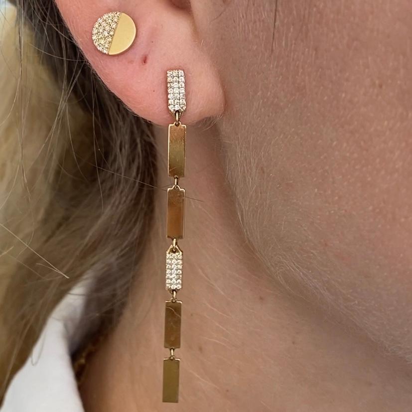 These sleek bar tag drop earrings are gorgeously modern and look perfect on any ear. Each earring sits about 2.3 inches long with six tiny bar tags linked together to form a gorgeous dynamic line that catches the light with your every move. The