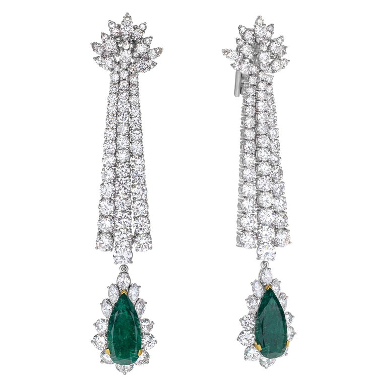 ESTIMATED RETAIL $126000 - YOUR PRICE $74400 - 100% AUTHENTIC - Supreme Elegance! Diamond drop earrings with approximately 20 carats in H-I color, SI clarity round brilliant cut diamonds, and approximately 9 carats in pear-cut Emerald drops set in