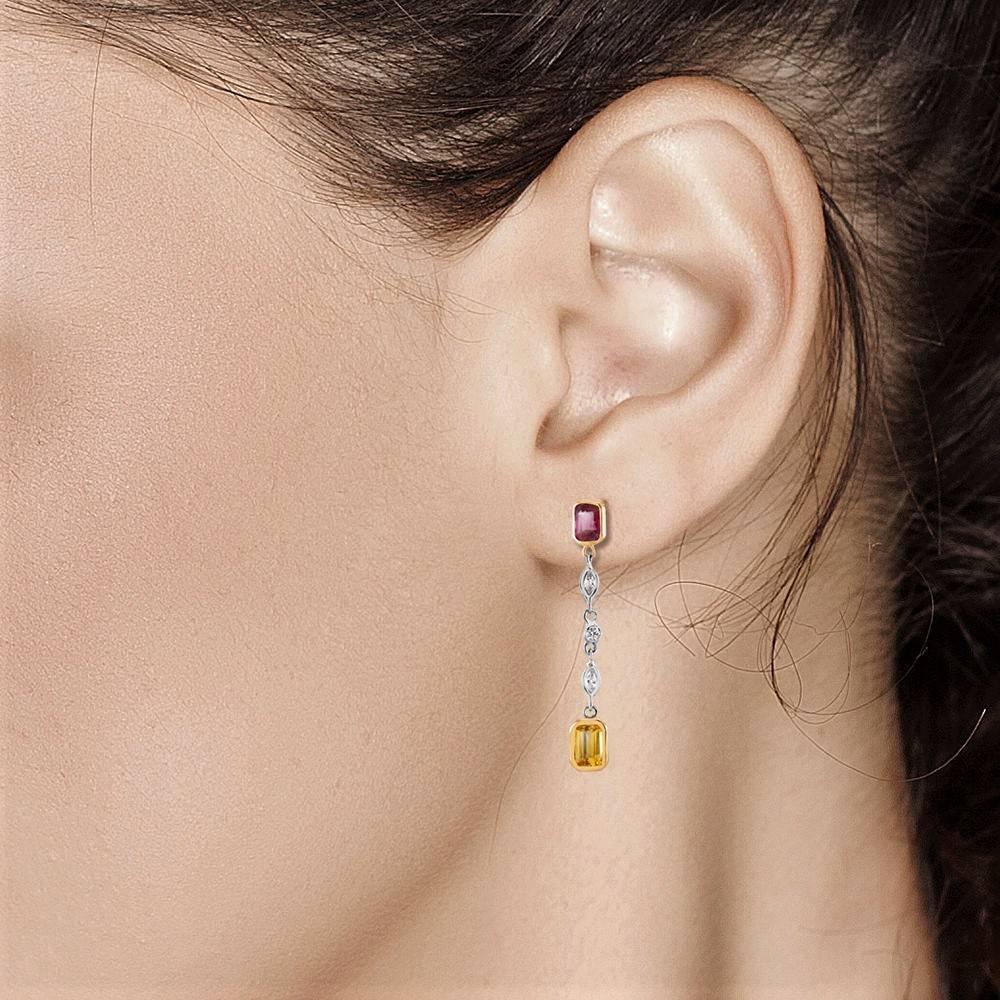 Featuring one of a kind earrings with emerald cut bezel-set ruby alternating emerald cut yellow sapphire and spaced by marquise shape and brilliant cut round diamond 
14k white gold alternating with yellow gold bezels, 1.5