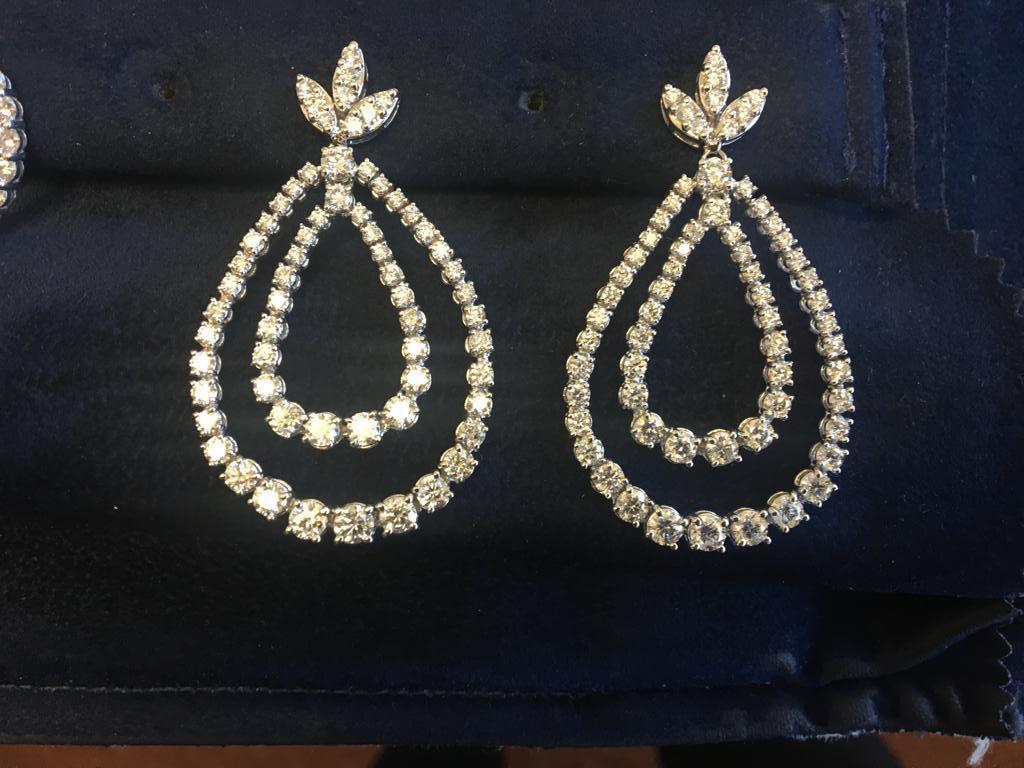 These earrings are manufactured in Italy.  It's the most stunning piece of our collection. The earrings are set in 18K white gold. The carat weight is 7.68, the clarity is SI and the color is G-H.