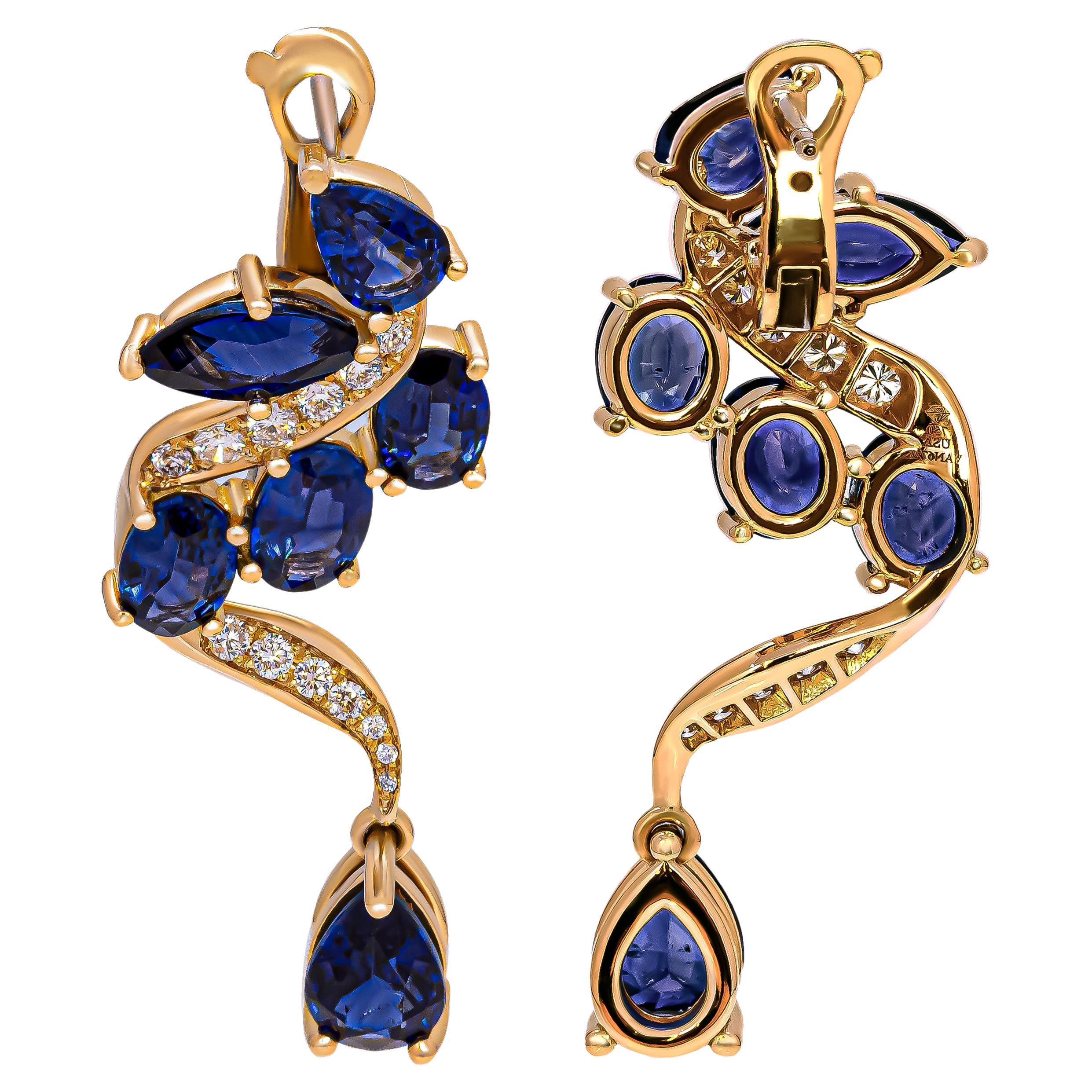 Welcome to our exquisite collection of Drop Earrings crafted in luxurious 18k yellow gold, adorned with the captivating beauty of Blue Sapphires and Diamonds. These elegant earrings showcase a mesmerizing arrangement of gemstones, featuring 6 oval