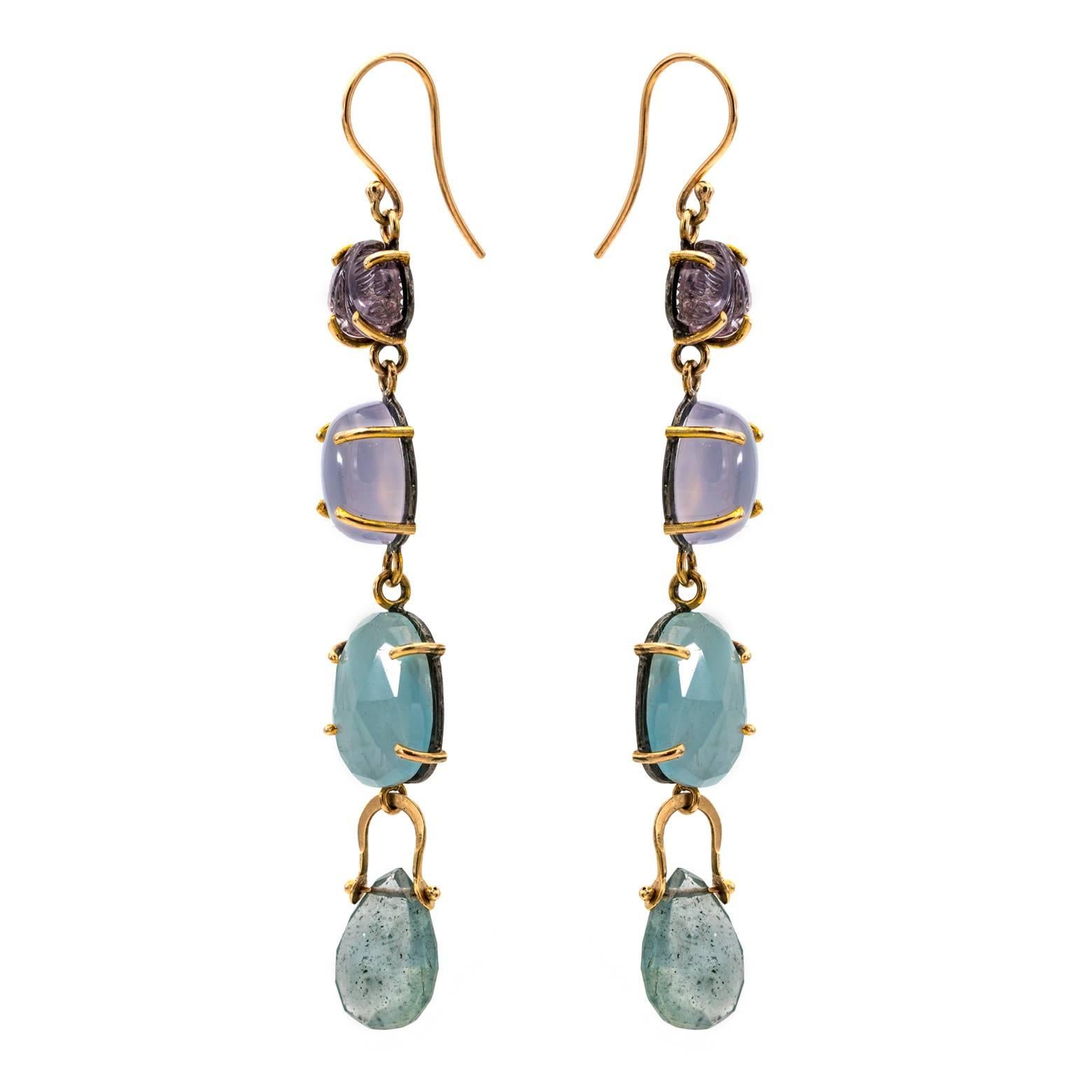 These yummy earrings are full of color with several complimentary colors in aquamarine, moss aqua and chalcadony. The carved stones at the top are tourmaline in the shape of a bud. The 14k accents beautifully display all the yummy colors and the