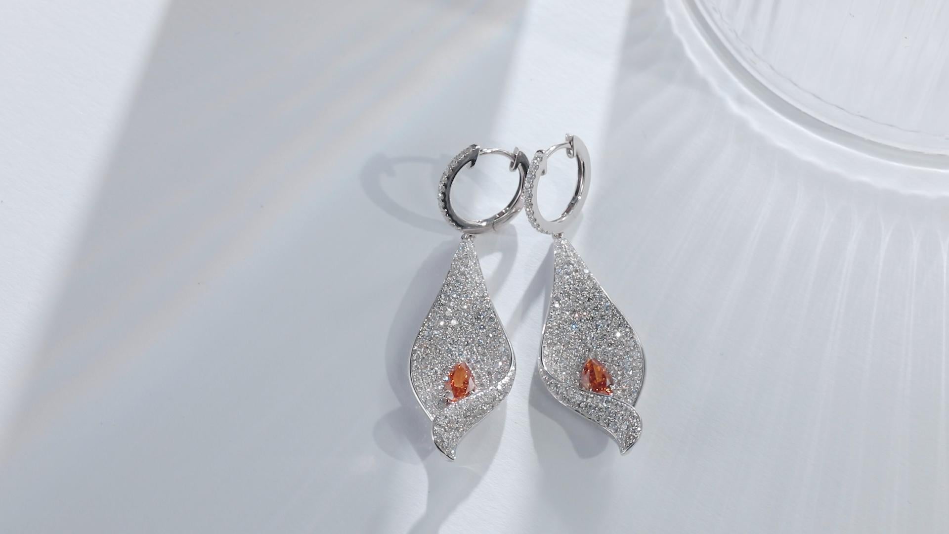 Exquisite 18K White Gold Earrings with GIA-Certified Fancy Vivid Yellowish Orange Diamonds

Discover the radiant beauty of these luxurious earrings, crafted in gleaming 18K white gold and featuring GIA-certified center stones with a combined weight