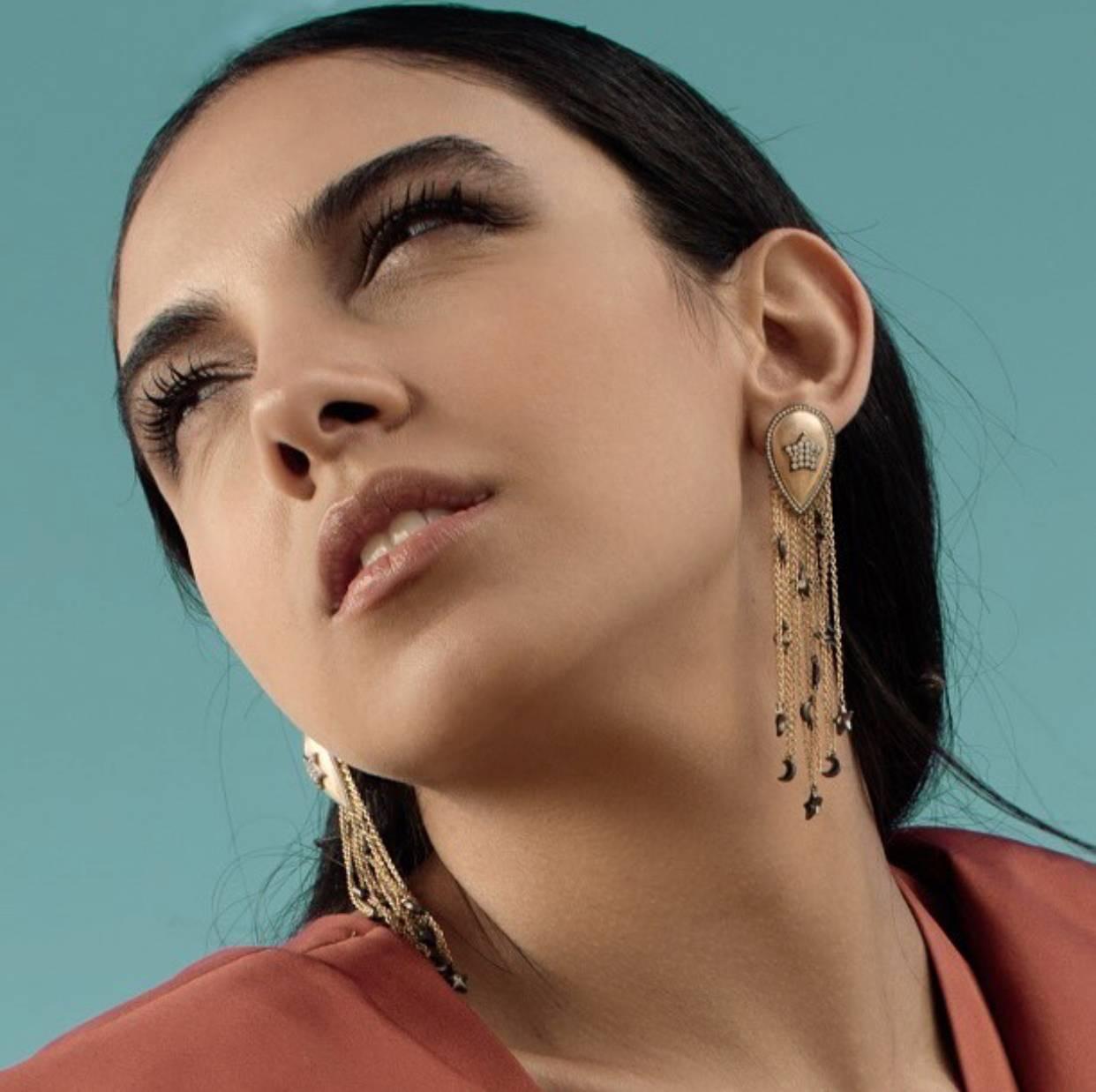 Part of AMMANII's Sa'mma = Sky Collection. Homage to the sky, the universal blanket that covers mankind and connects us all under its wings. The drop earrings with moon and stars tassels stand for all the women; the radiant stars, givers of light