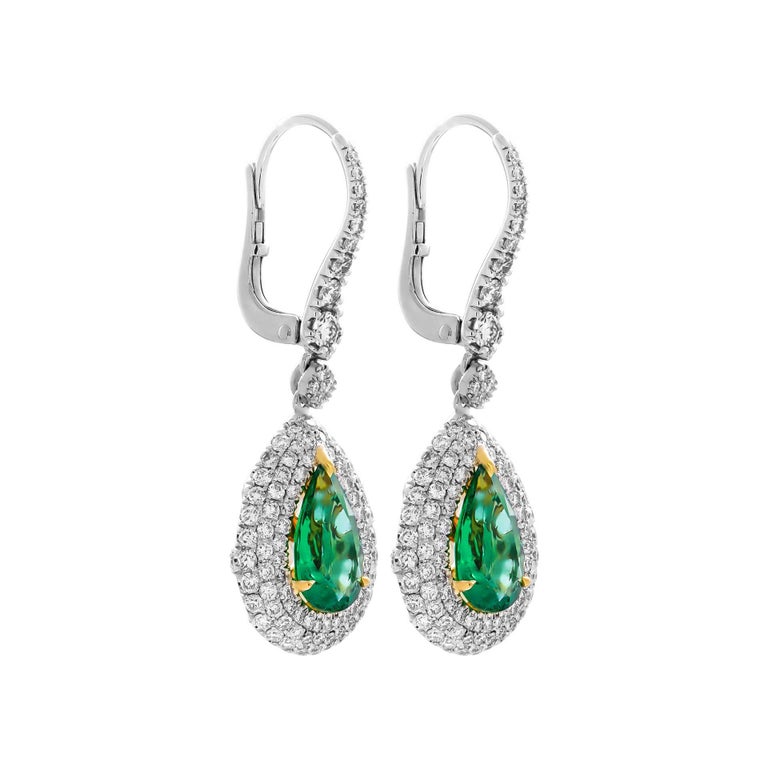 Drop Earrings with Pear Shape Emeralds and diamonds
Mounted in 18K White & Yellow Gold with 3 row pave halo around Emeralds and Diamond gallery on the back 
Each stone is 3.48ct Natural Green Emerald Pear Shape , originated in Africa
Total carat