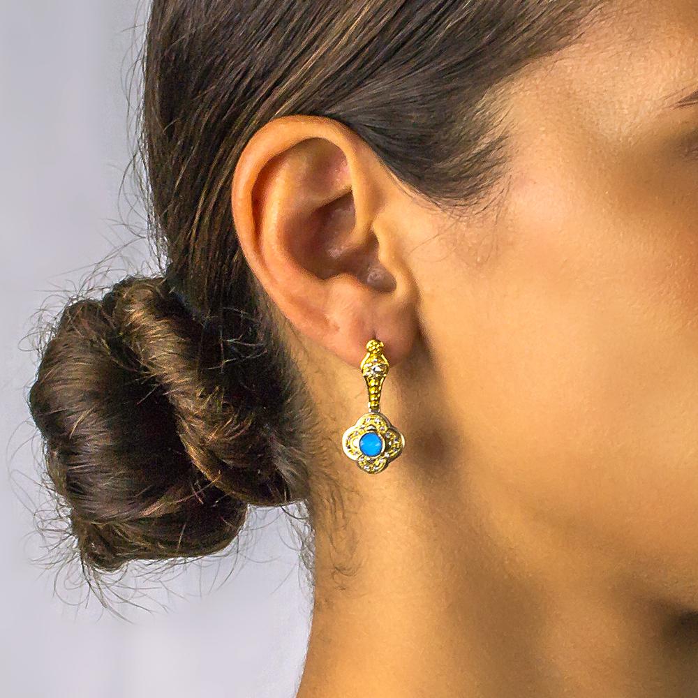 Earrings with turquoise stone and zircon gemstones around the gold plated ornate bezel.

The turquoise stone got its name from the French word 