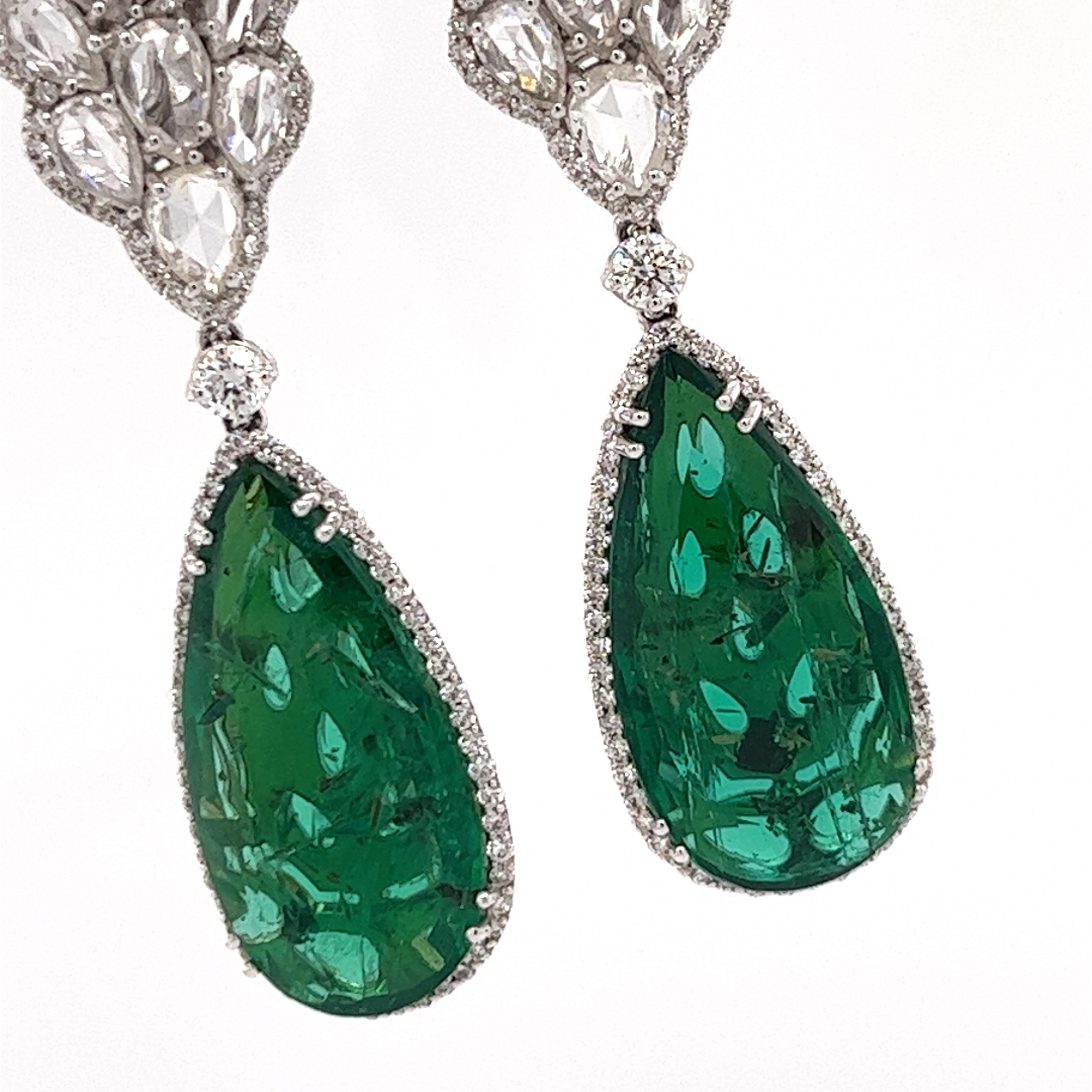 Drop Emeralds and Diamonds Earrings  18KT White Gold  GIA CERTIFIED

GIA CERTIFICATED. REPORT # 6214485271

Weight 9.60 and 9.72 Grams (GROSS)

Diamond Cut 200 PIECES, 1.13 CTS, H-G, VS

Rosecut Diamonds 30 PIECES 4.27 CTS. G-F, VS

Natural Emeralds