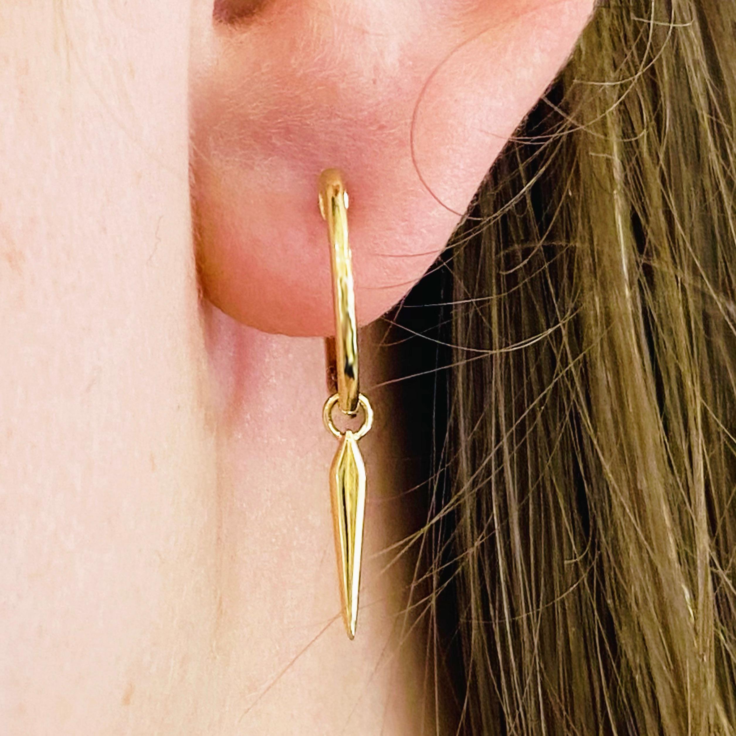 These stunning 14k yellow gold spike drop huggie hoops provide a look that is both trendy and classic. These earrings are a great staple to add to your collection, and can be worn with both casual and formal wear.  These earrings would make the