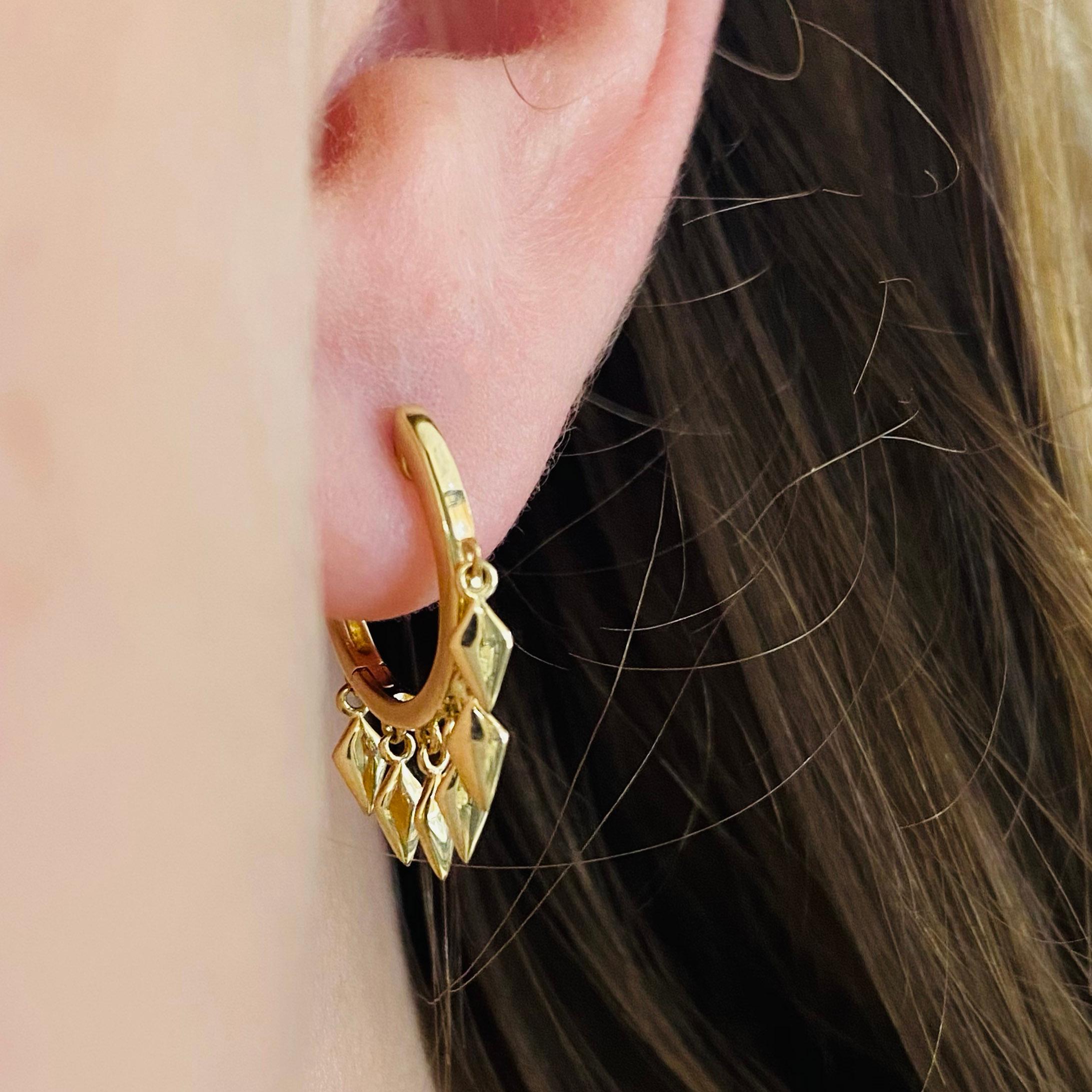 These stunning 14k yellow gold spike drop huggie hoops provide a look that is both trendy and classic. These earrings are a great staple to add to your collection, and can be worn with both casual and formal wear.  These earrings would make the