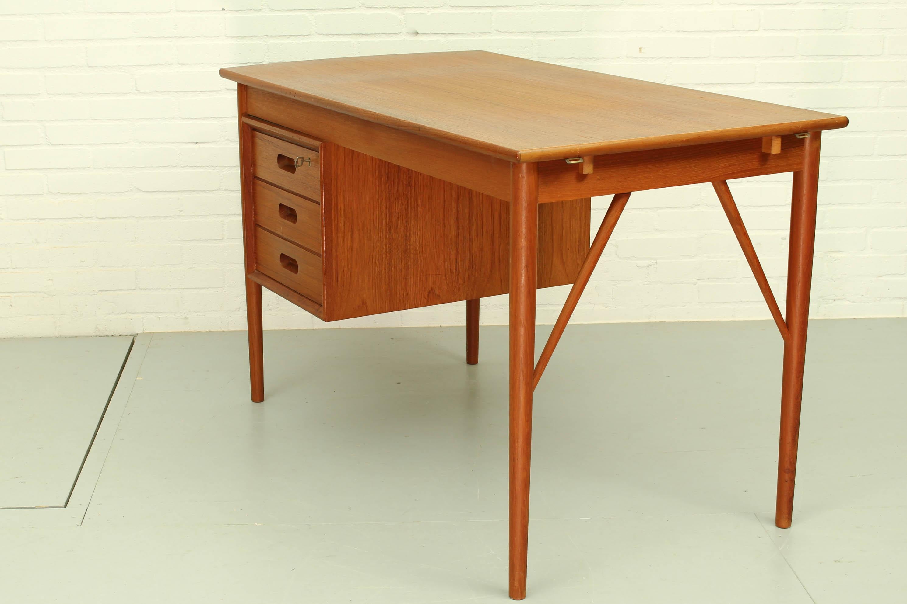 Smart Danish teak drop leaf desk by Erik Buch, 1970s. It has a double sided cabinet, with 3 drawers on one side and a display shelve on the other side. Clever little detail: the drop leaf that allows to enlarge the office if necessary.