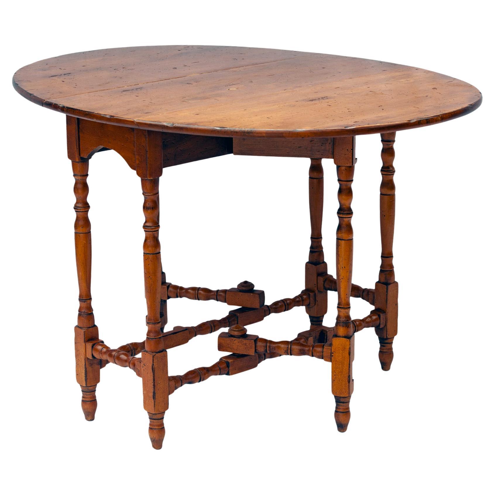 Vintage gate leg table with two D-shaped drop leaves, turned leg, supports & stretchers. When opened the table extends to a sizable oval, as useful today as it was years ago.
Rich caramel hues beam beneath a wax polish finish displaying a desirable