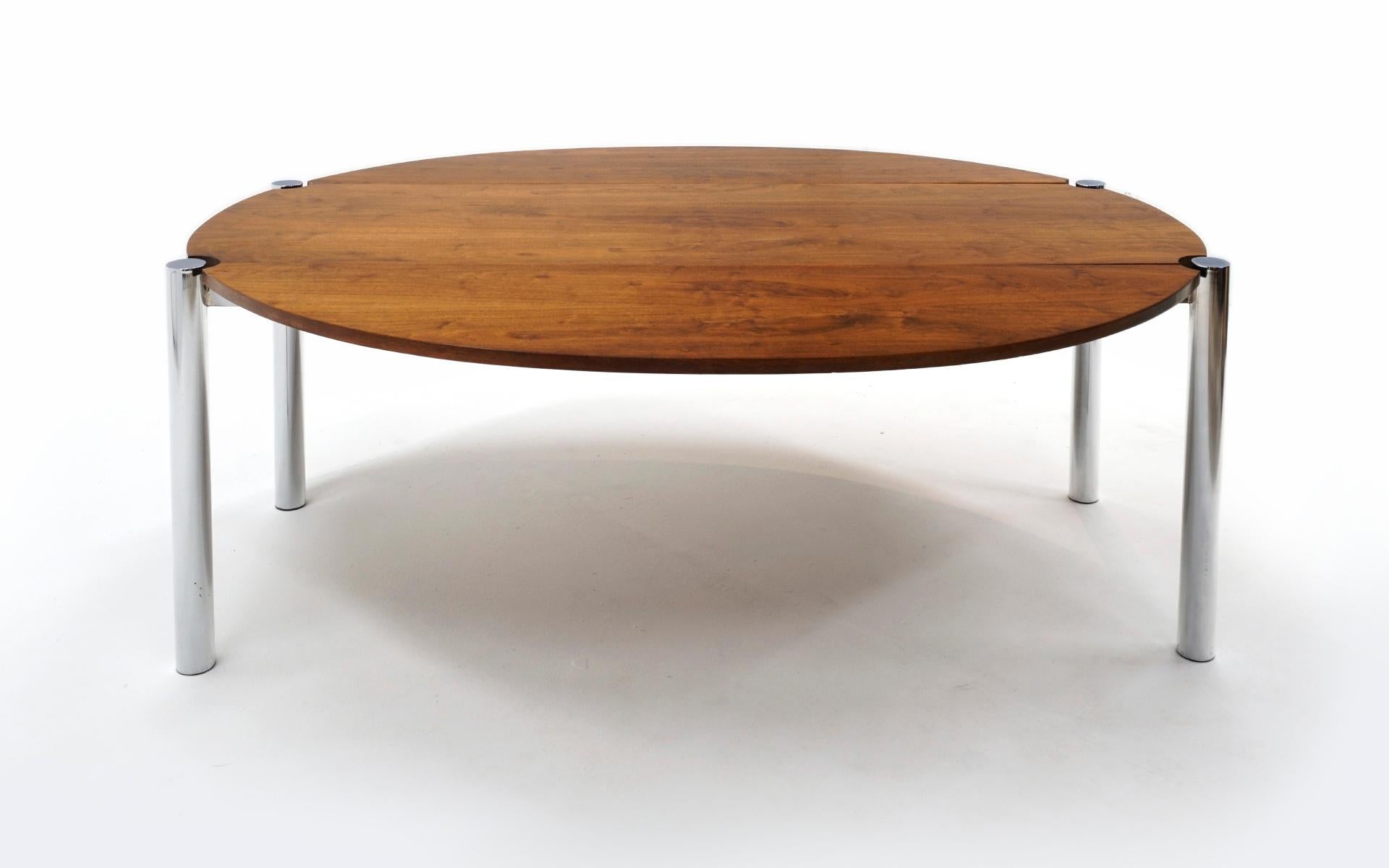 Rosewood drop-leaf dining / sofa table with round chrome legs. 72 inches long, 28 1/2 inches high and 27 3/4 inches deep with the leaves down and 60 1/2 inches wide with the leaves up. Light scratches in the finish and some light indentations.